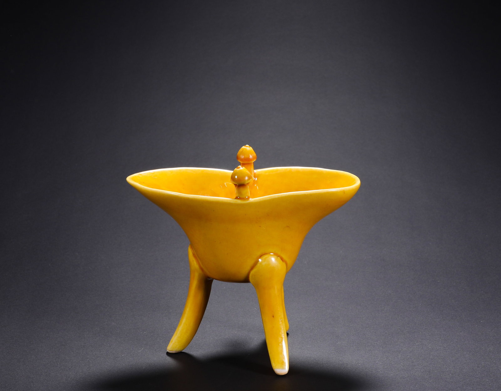 A YELLOW GLAZED THREE-LEGGED WINE CUP FROM THE MING DYNASTY'S JIAJING PERIOD: H:11cmW:12cm