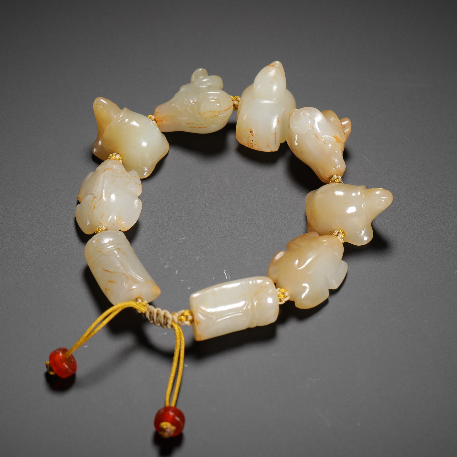 HAN DYNASTY HETIAN JADE PENDANT WITH AUSPICIOUS BEAST AND CICADA PATTERNS: H:2cm (0.79in) Weight:70g (0.15lb)This is a Han Dynasty Hetian jade bracelet, composed of white jade auspicious beast pendants and cicada-shaped lezi beads. The jade has a smooth texture with natural 