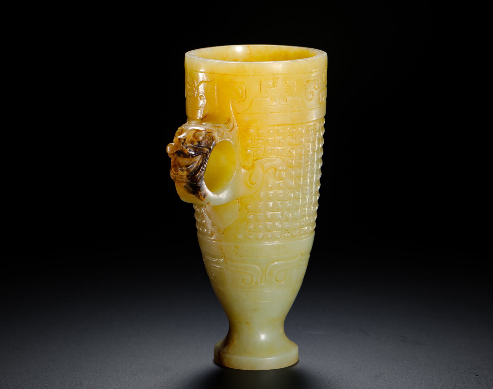 HAN DYNASTY HETIAN JADE GRAIN PATTERN CHILONG EAR CUP: H:11.5cm (4.53in) W:9cm (3.54in) Weight:240g (0.53lb)This is a Han Dynasty Hetian jade cup, carved from smooth jade with natural patina and local "black patina" features. The body is fully decorated w