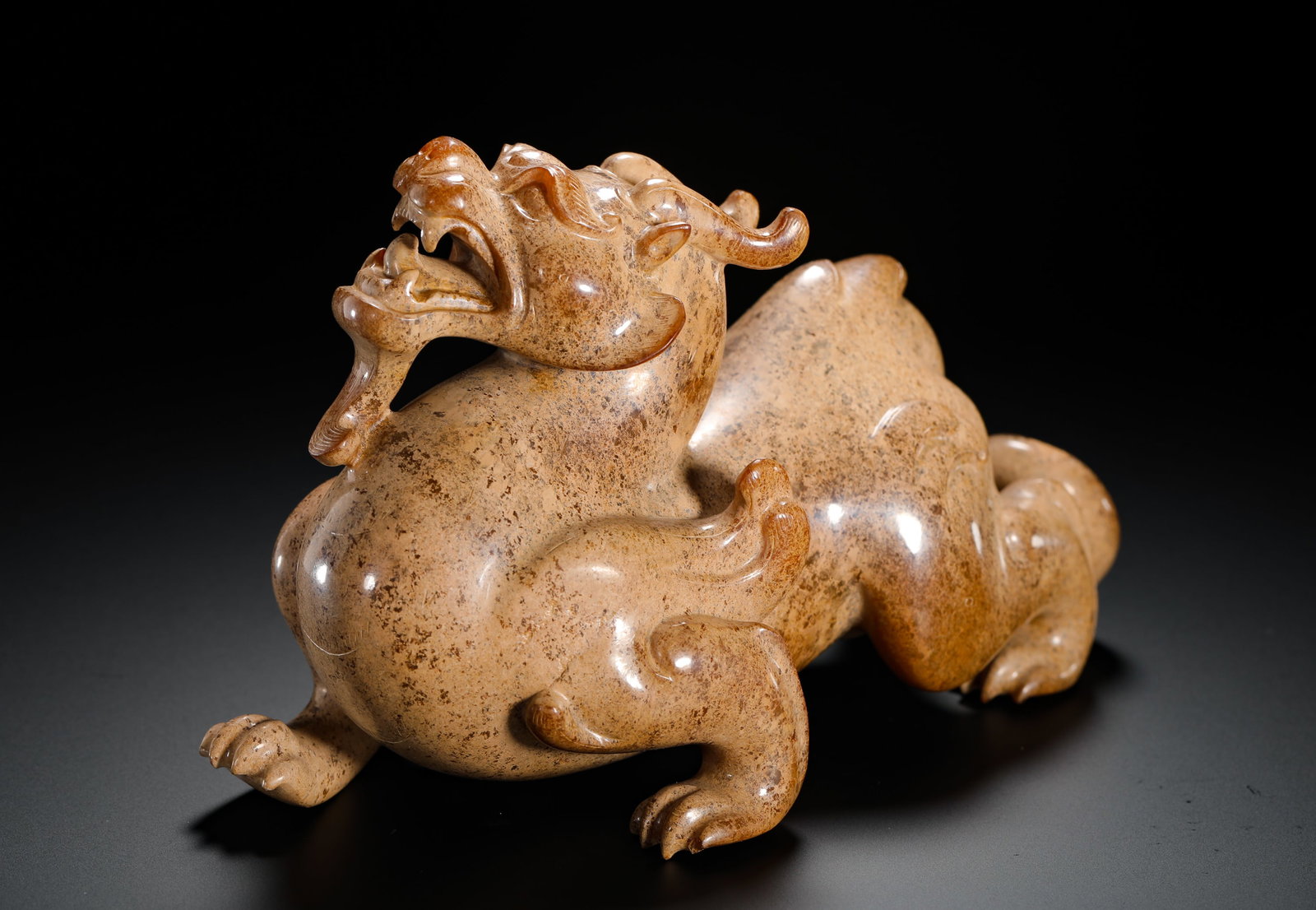 HAN DYNASTY HETIAN JADE TIANLU AUSPICIOUS BEAST ORNAMENT: H:10cm (3.94in) W:16.5cm (6.50in) Weight:990g (2.18lb)This is a Han Dynasty Hetian jade Tianlu ornament. The jade is heavily patinated, presenting an ancient earthy-yellow color with calcification tra