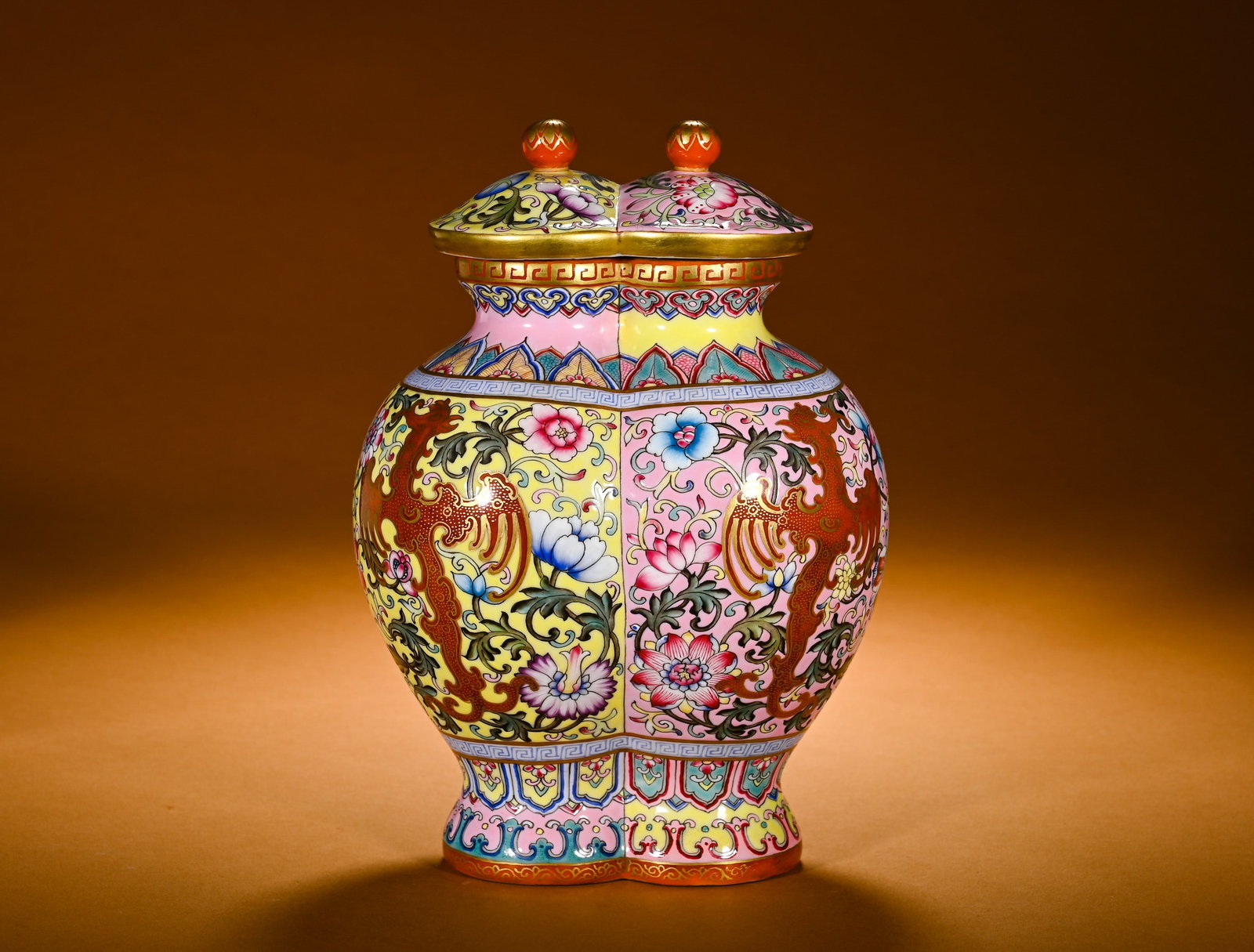 QING DYNASTY PASTEL YELLOW POWDER GROUND GILDED KUI PHOENIX-PATTERNED DOUBLE-LIDED JAR: Height:21cm(8.27in)Width:16cm(6.30in)Weight:900g(1.98lb)Famille rose conjoined covered jar with phoenix and floral scroll, gilded detail. Unique twin conjoint body with matching dual-knob lid,