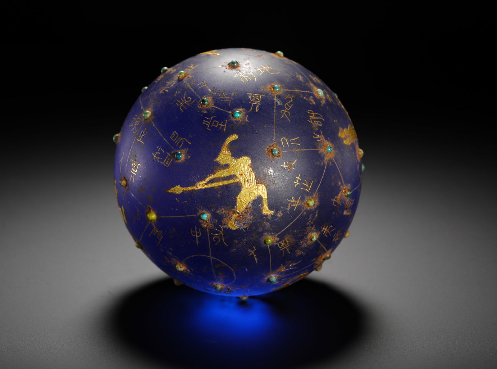 HAN DYNASTY GLASSWARE WITH GOLD INLAID TURQUOISE ASTRONOMICAL STAR SPHERE: D:10cm(3.94in) Weight:1230g(2.71lb)Han Dynasty deep blue glass celestial sphere inlaid with gold and turquoise. The translucent blue glass ball is engraved with gold thread constellation lines, gold s