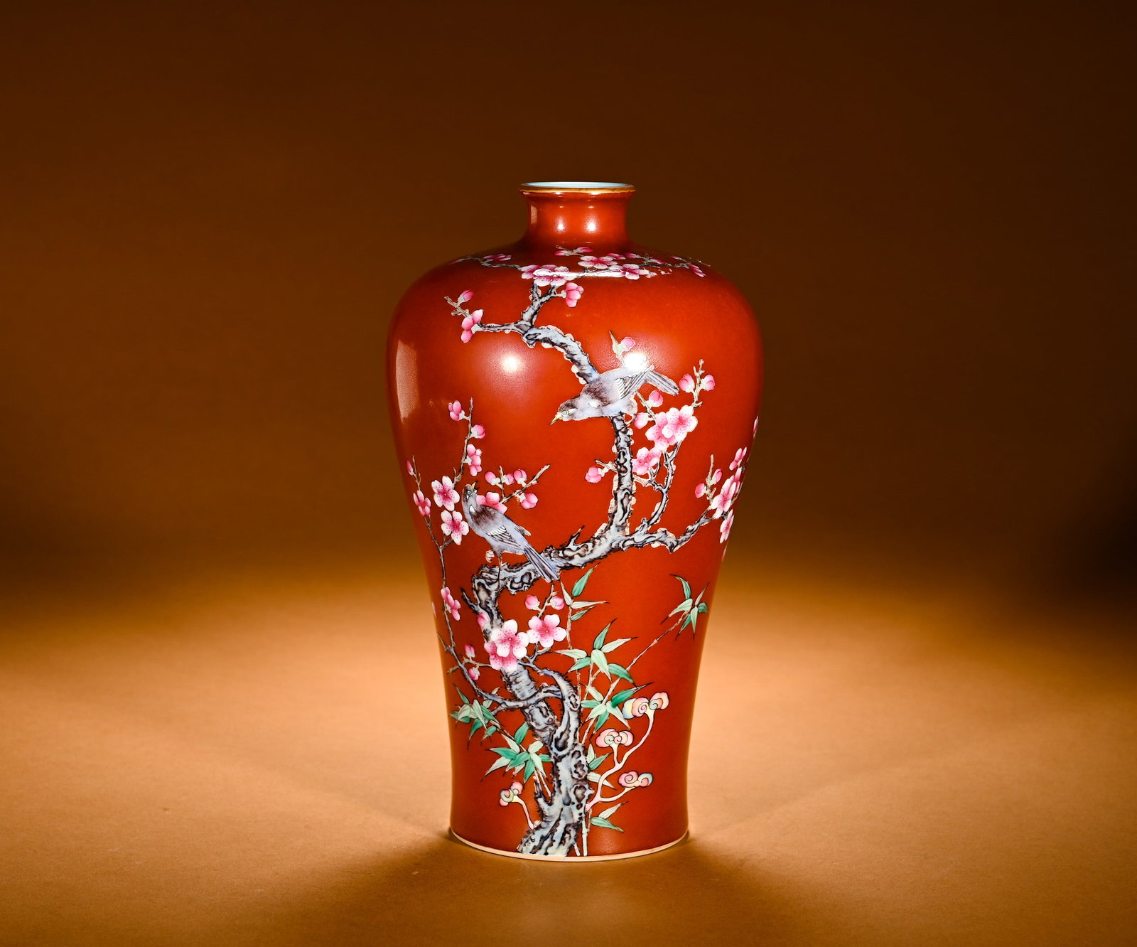 QING DYNASTY CORAL RED GROUND PASTEL MAGPIE ASCENDING PLUM PATTERN PLUM VASE: Height:23cm(9.06in)Width:14cm(5.51in)Weight:850g(1.87lb)Famille rose prunus and magpie vase on coral-red ground. Classic meiping shape with small mouth, short neck, plump shoulder and tapered belly. C