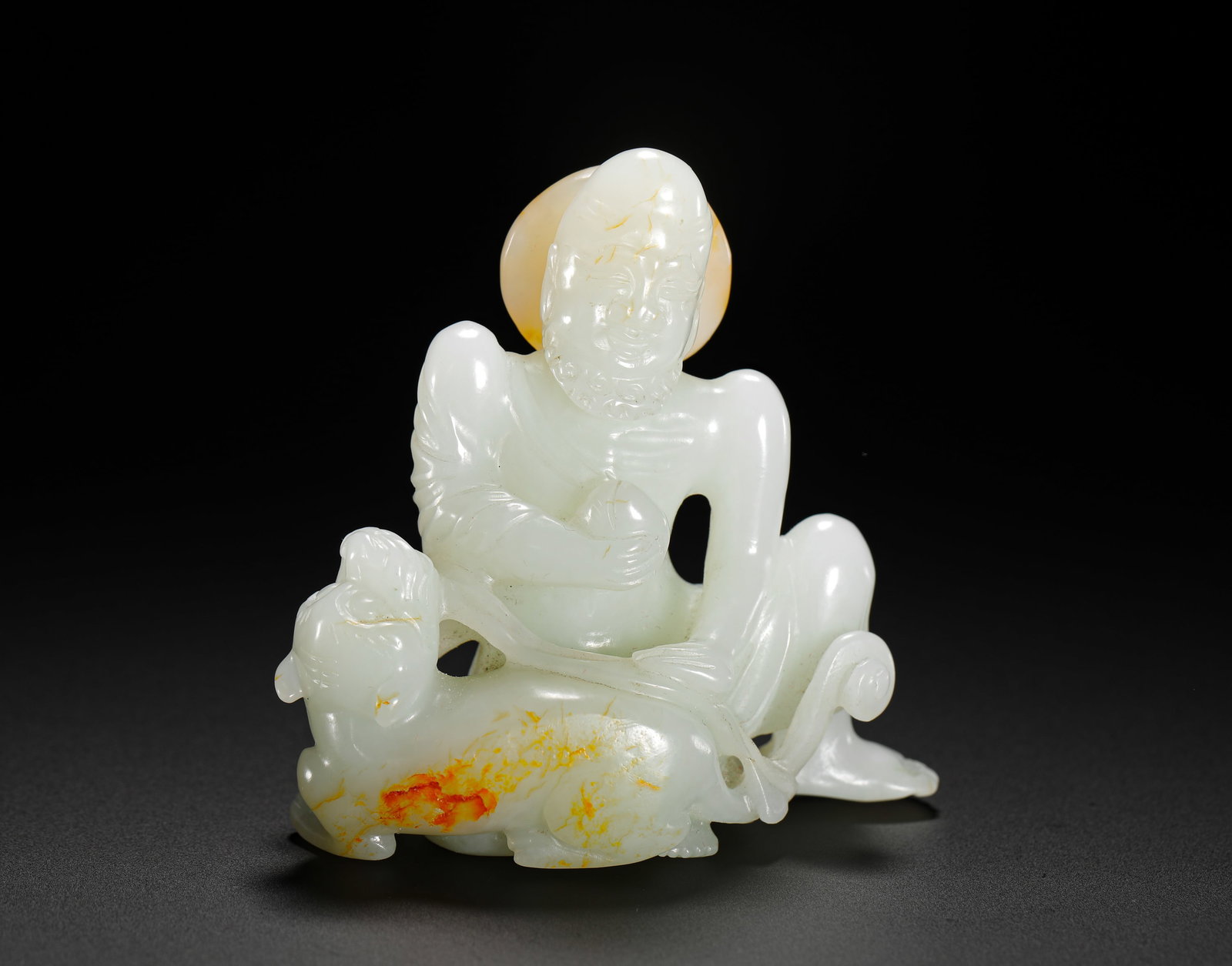 QING DYNASTY HETIAN JADE SEATED FIGURE OF THE TIGER SUBDUING ARHAT: Height:6.7cm(2.64in) Width:7cm(2.76in) Weight:110g(0.24lb)Qing Dynasty Hetian white jade carved Arhat subduing tiger statue. Integrated hollowed jade carving, the arhat sits casually with pearl in han