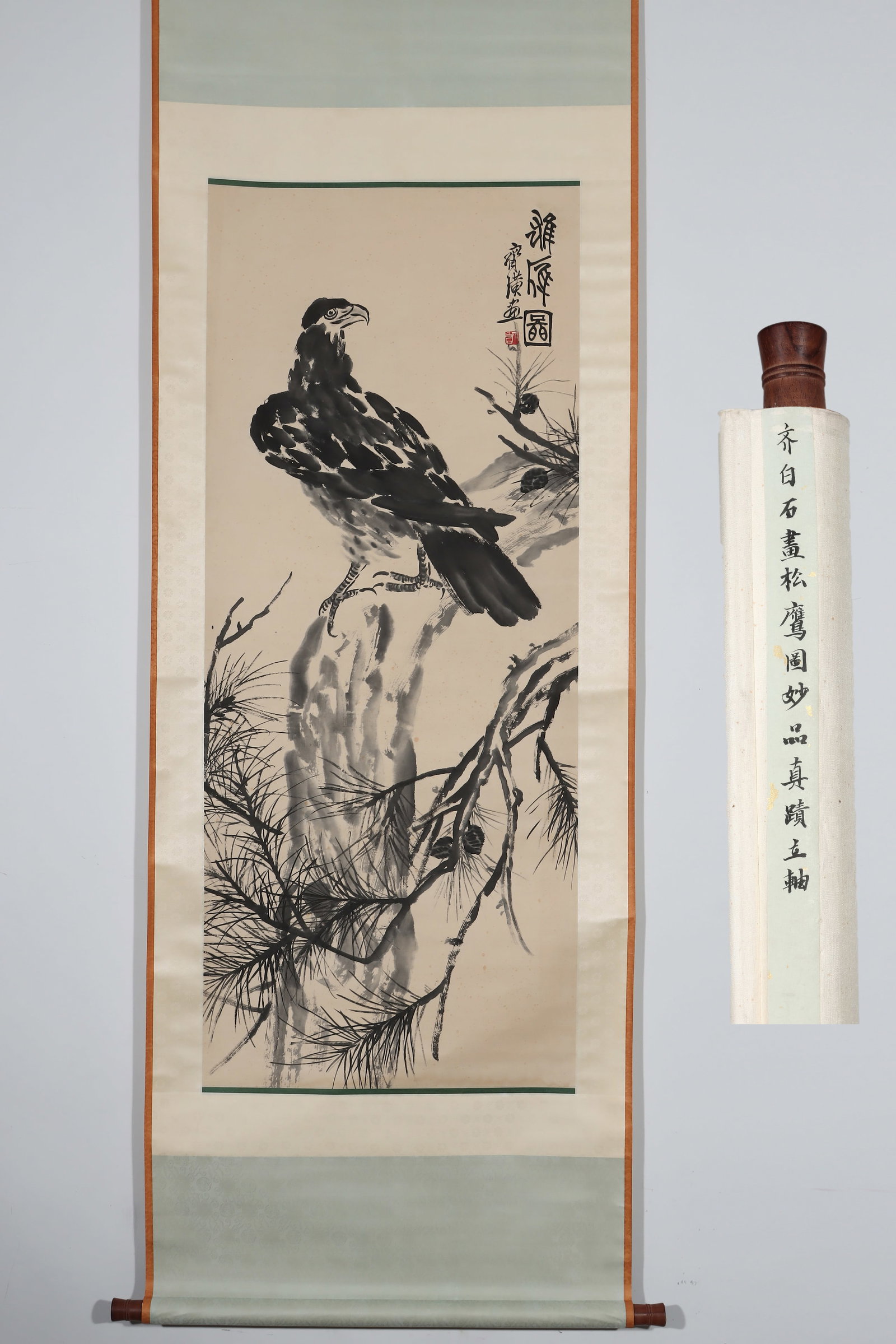 IN QI BAISHI'S (1864-1957) PICTURE OF PINE AND EAGLE: Height:137.5cm(54.13in) Width:57cm(22.44in)Ink flower-and-bird vertical scroll on paper. The work depicts a powerful eagle perched on ancient pine branches. Rendered in bold freehand brushwork, the co