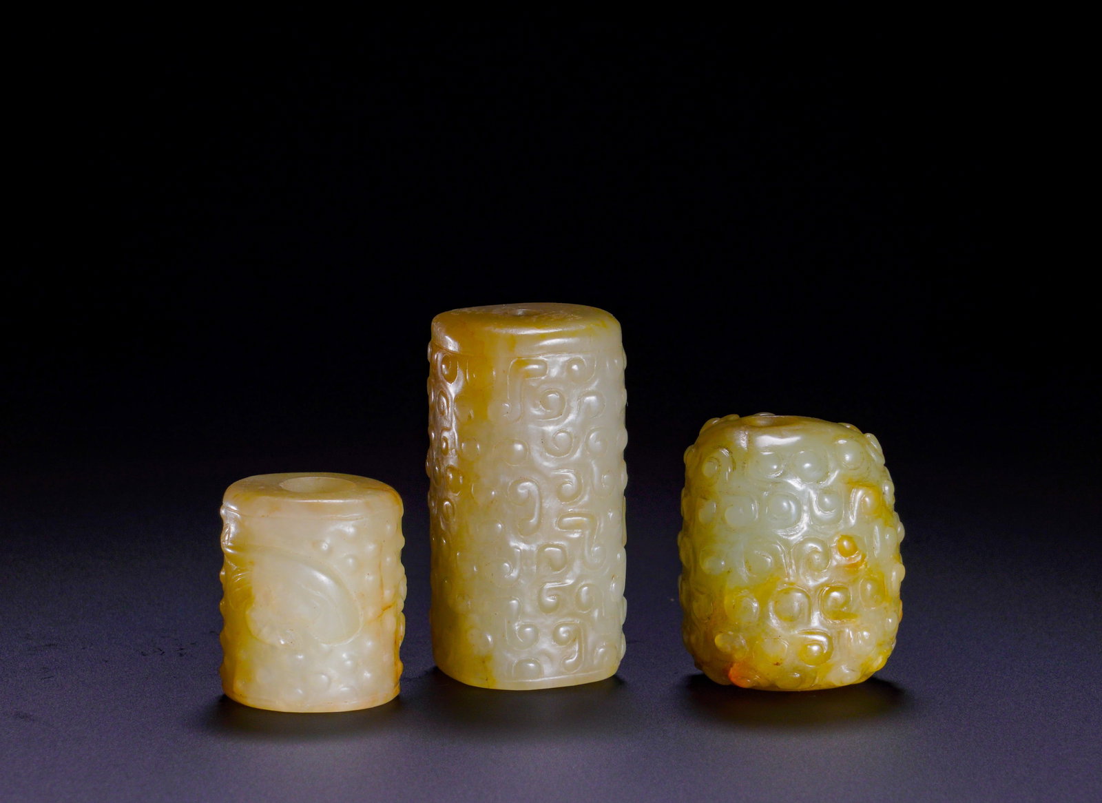THREE PIECES OF HAN DYNASTY JADE LEZI IN A SET: MaximumHeight:3.8cm(1.50in)Width:2cm(0.79in)Weight:70g(0.15lb)Han Dynasty Hetian jade tube beads (set of three).Each cylindrical bead has a central through hole, serving as essential fittings of Han c