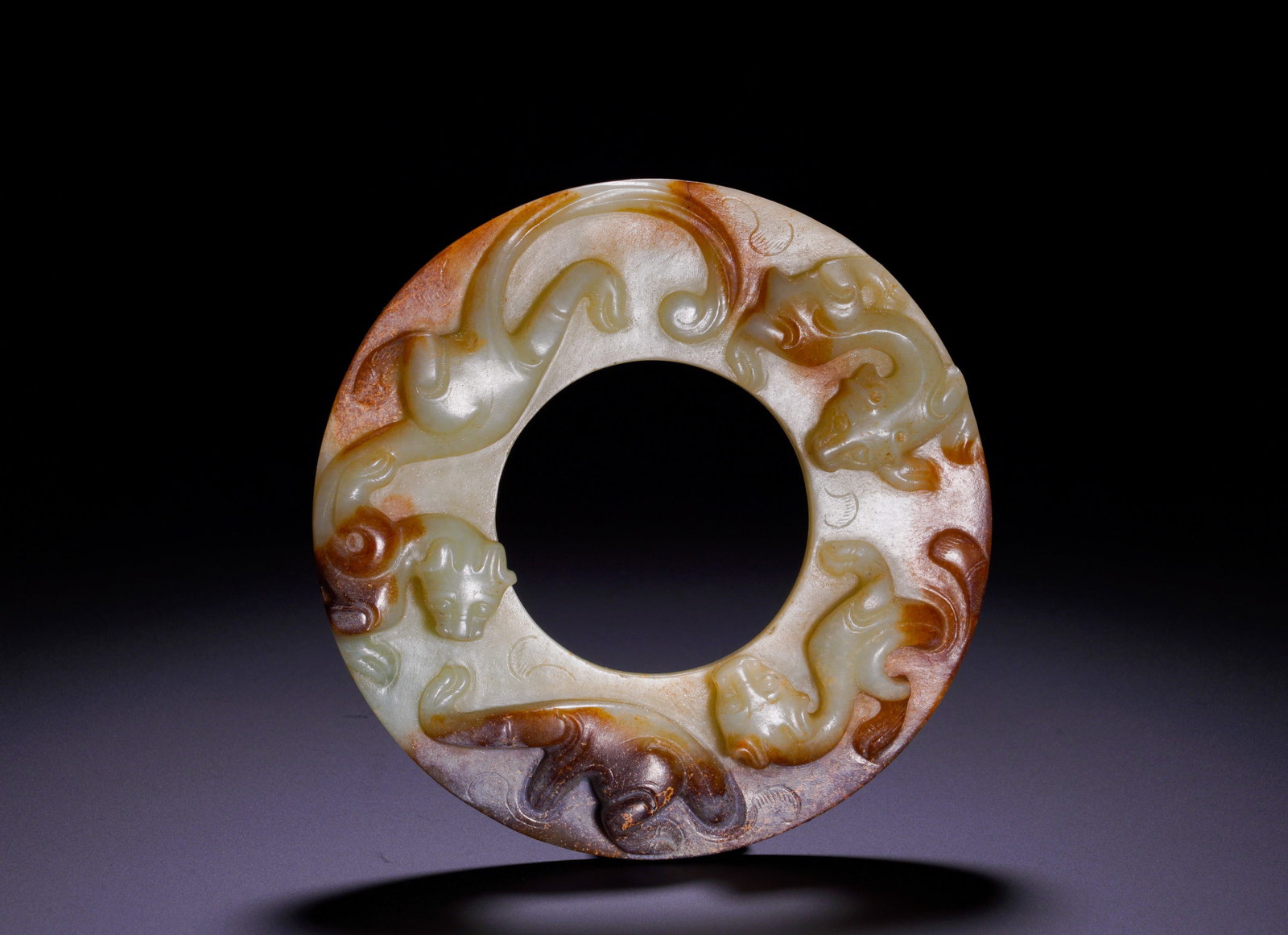 HAN DYNASTY FOUR CHI DRAGON JADE DISC: Diameter:12.3cm(4.84in)Weight:220g(0.48lb)Han Dynasty jade bi with four chilong.The jade disc bears elegant natural reddish patina. Four winding chilong are carved in high relief. As popular auspiciou