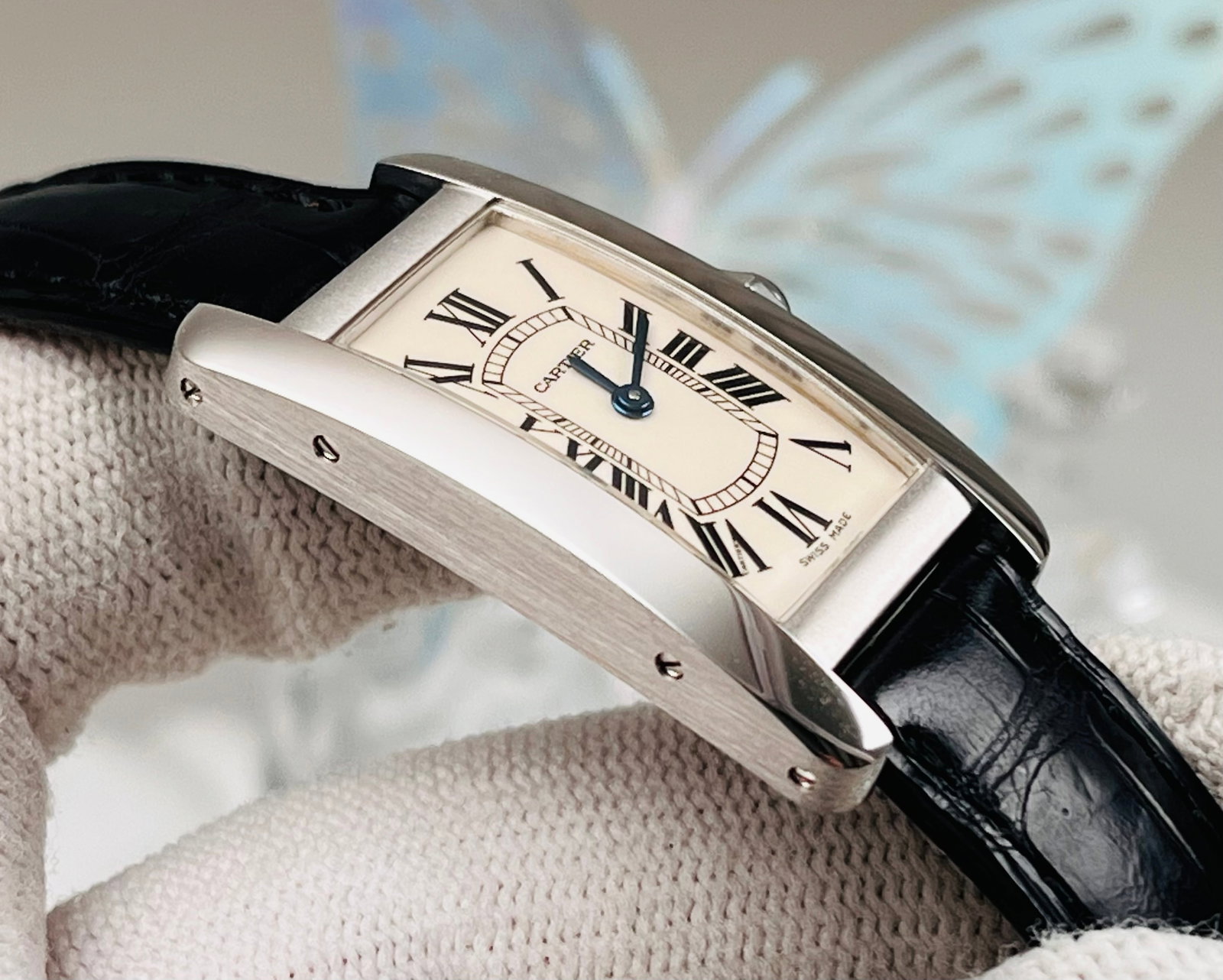 CARTIER TANK COLLECTION WATCHES: 35.8 mm curved 18K white gold case, quartz movement, white dial with classic Roman numerals and a sapphire crown