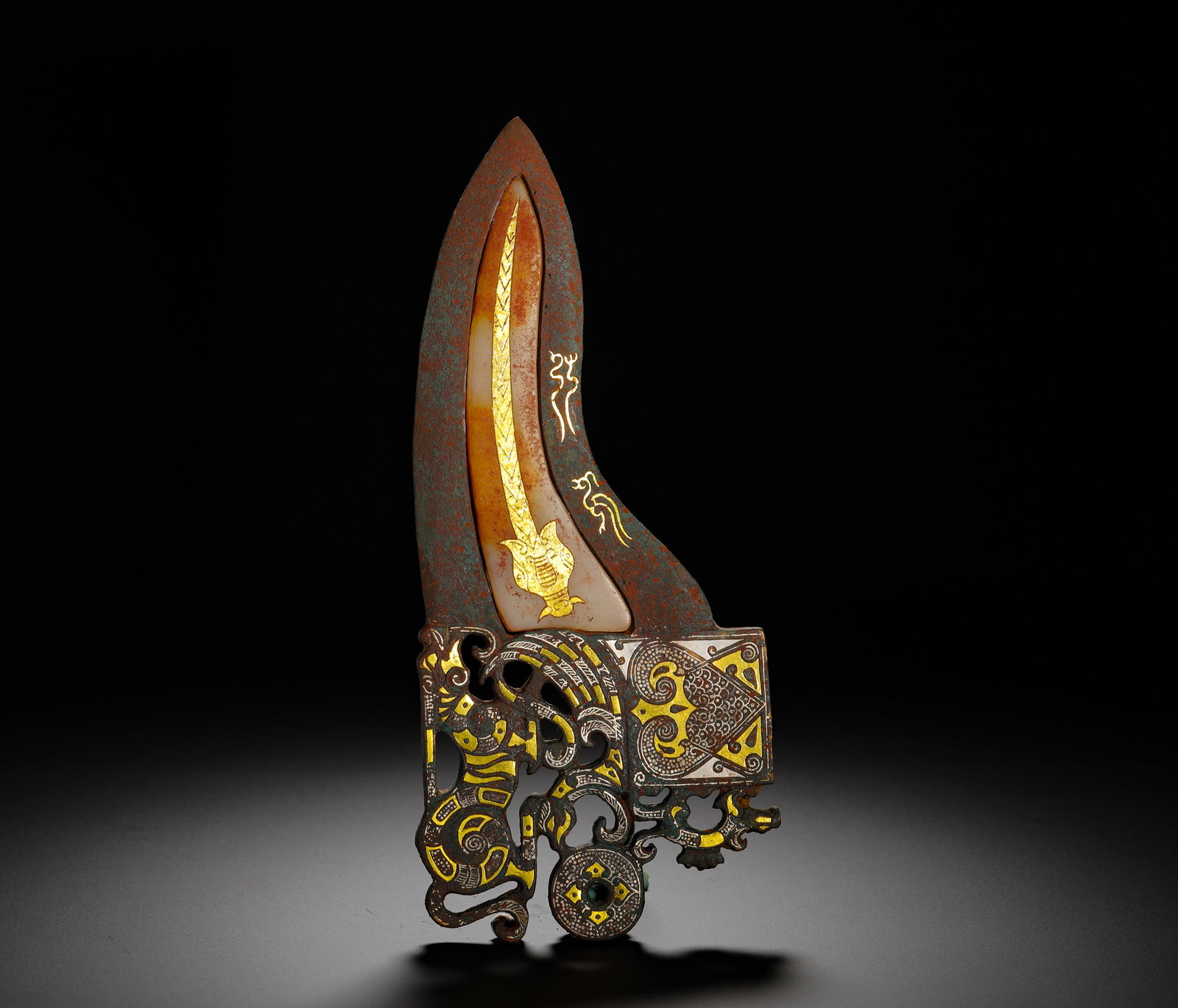THE CEREMONIAL HALBERDS OF THE KINGS OF THE WARRING STATES PERIOD: Height:20.5cm(8.07in) Width:9cm(3.54in) Weight:460g(1.01lb)Warring States ritual bronze ge dagger-axe inlaid with gold, silver and white jade for royal parade, not designed for combat. The blade is gr