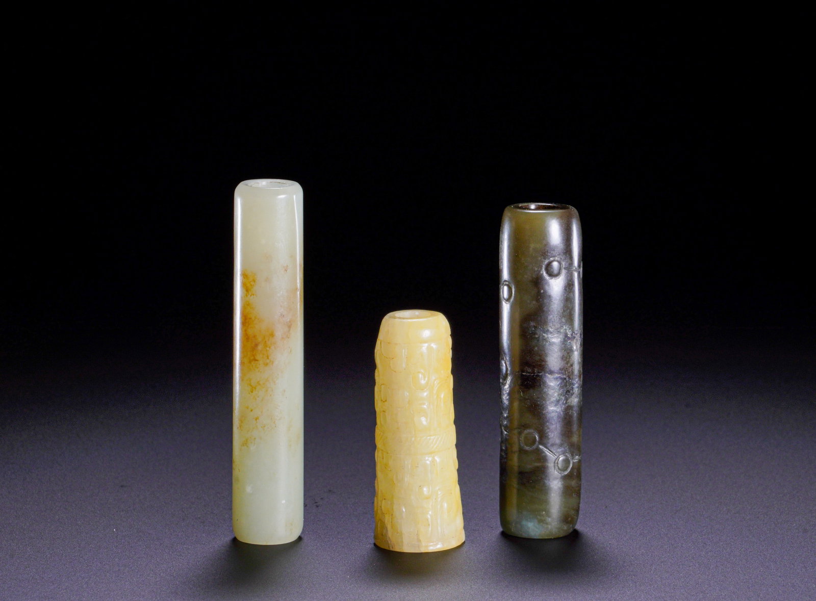 THREE PIECES OF HAN DYNASTY JADE LEZI IN A SET: MaximumHeight:5.6cm(2.20in)Weight:50g(0.11lb)Set of three jade tube beads of Han Dynasty.Every artifact has a central through hole, serving as essential parts of Han composite jade pendants.The long c