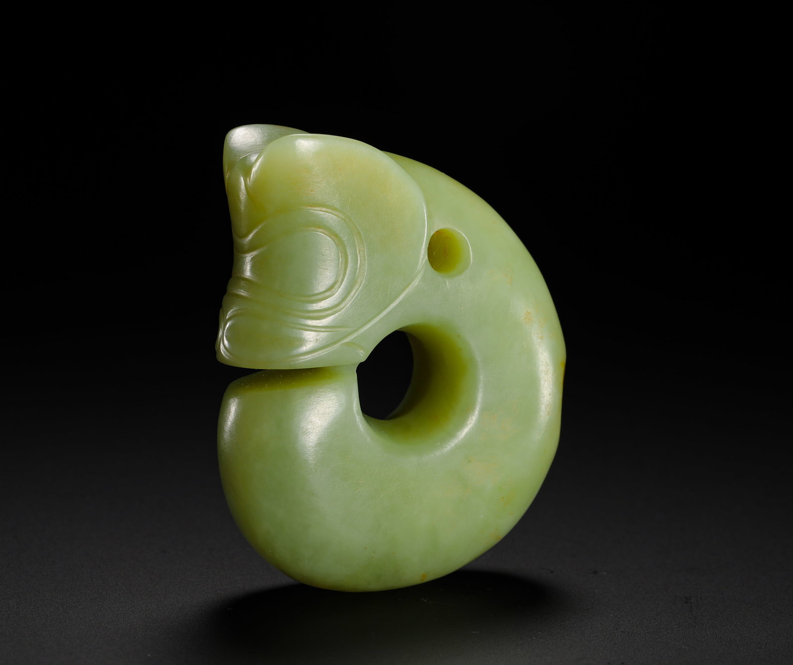 RED MOUNTAIN PERIOD JADE PIG-DRAGON: Height:6.5cm(2.56in) Width:5cm(1.97in) Weight:110g(0.24lb)Hongshan jade pig-dragon ritual pendant carved in C-shape. Solid whole-jade carving with coiled dragon head, smooth jade surface with light na