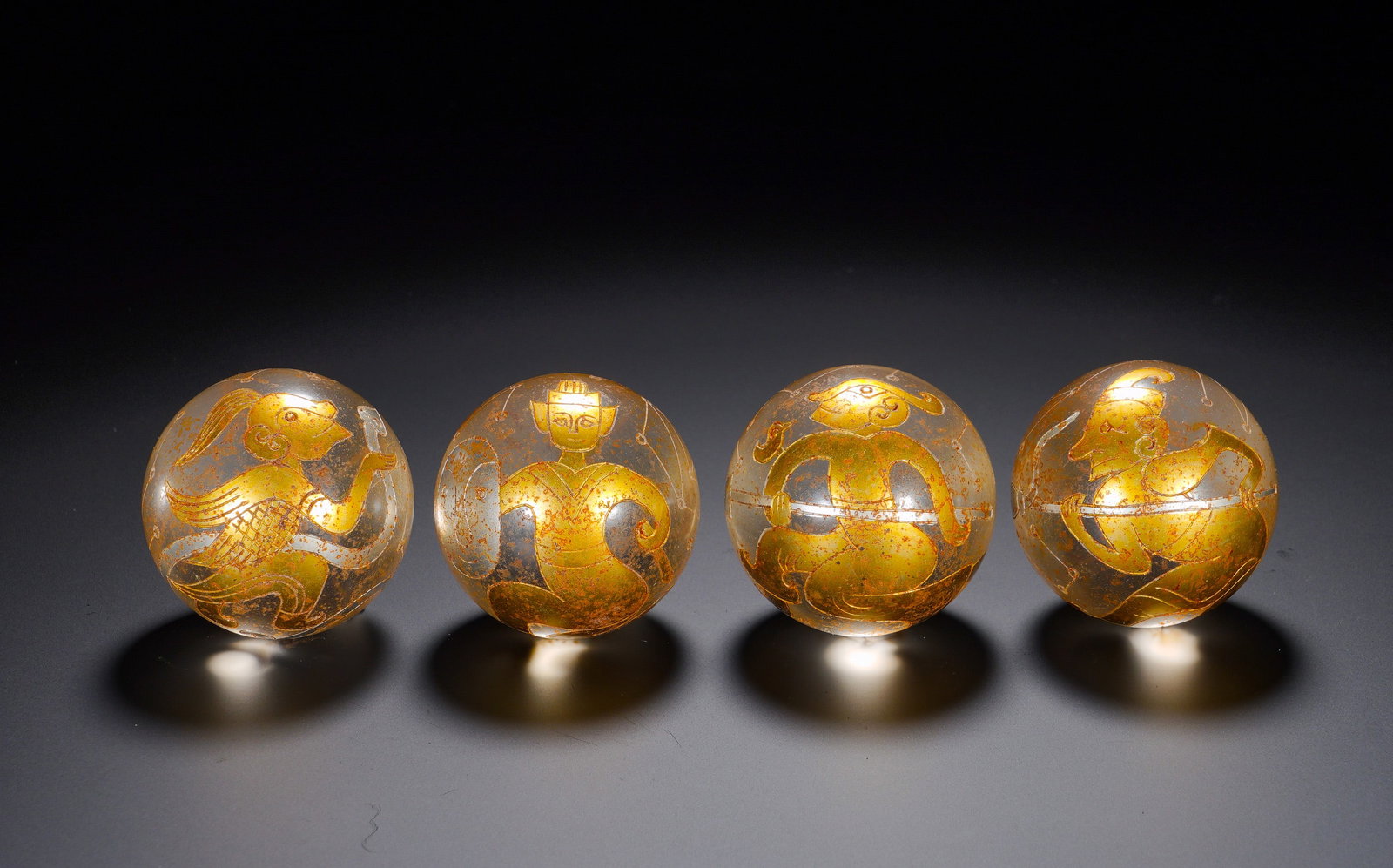 A SET OF FOUR HAN DYNASTY CRYSTAL BEADS WITH GOLD INLAID FEATHERED HUMAN, DIVINE AND BEAST PATTERNS (1 of 11)