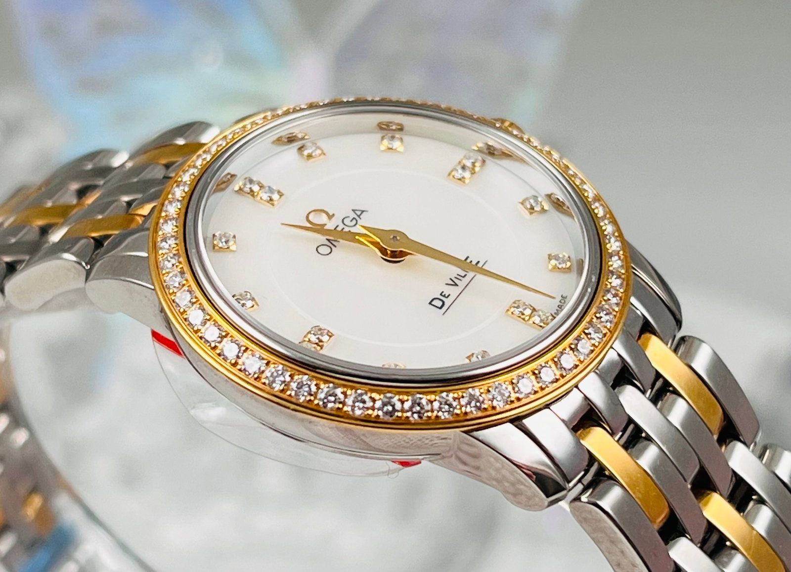 OMEGA DE VILLE MODEL WATCHES: Omega De Ville model, 27mm case diameter, stainless steel and 18K gold two-tone material, quartz movement, 18K gold bezel with diamonds, mother-of-pearl dial with diamond markers
