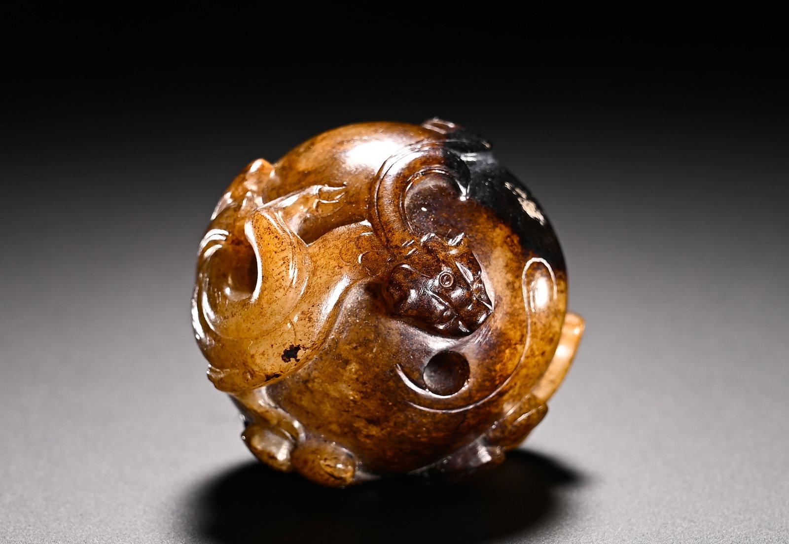 HAN DYNASTY HETIAN JADE BLACK QIN CHI LONG JADE BEAD PENDANT: Diameter:4cm(1.57in)Weight:100g(0.22lb)Han Dynasty Hetian jade spherical pendant carved with chi dragons and covered with dark russet patina. The plump spherical body is decorated with winding chi dra