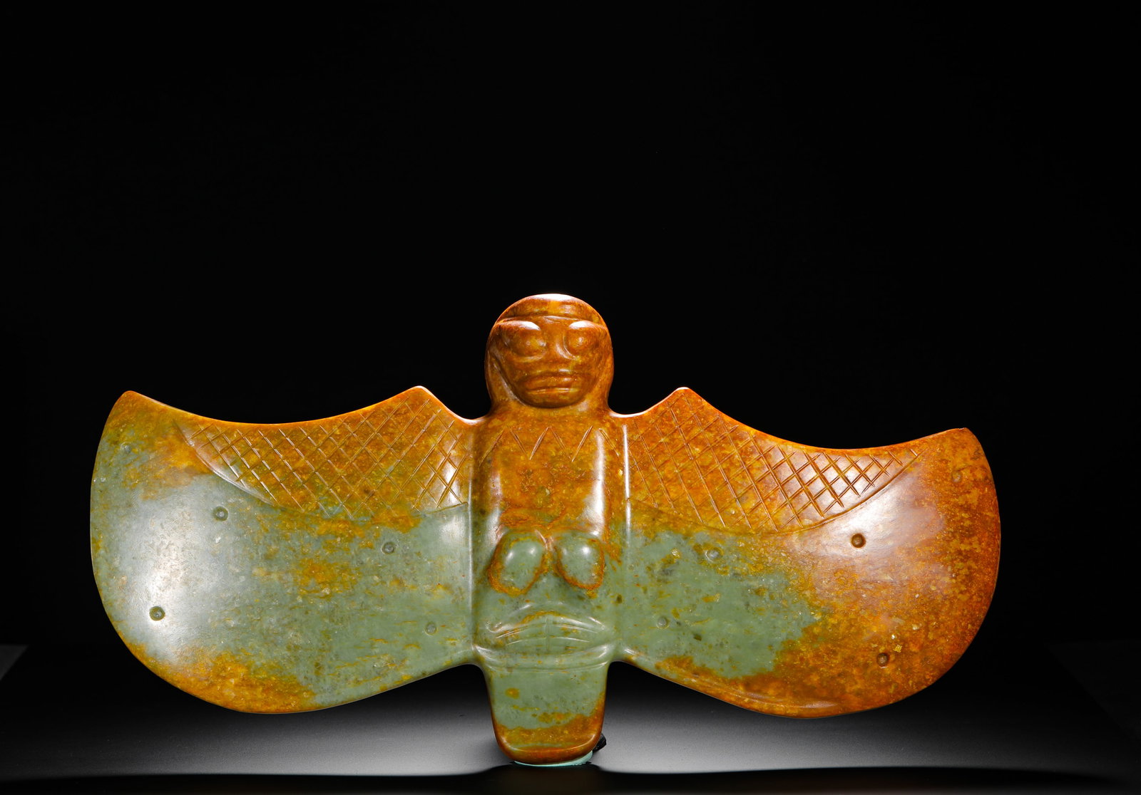 RED MOUNTAIN CULTURE DIVINE MAN JADE BIRD RITUAL VESSEL: Height:23cm(9.06in) Width:46cm(18.11in) Weight:3990g(8.80lb)Hongshan Culture jade owl ornament integrated with human deity, carved from serpentine jade. Flat slab carving with drilled suspension holes