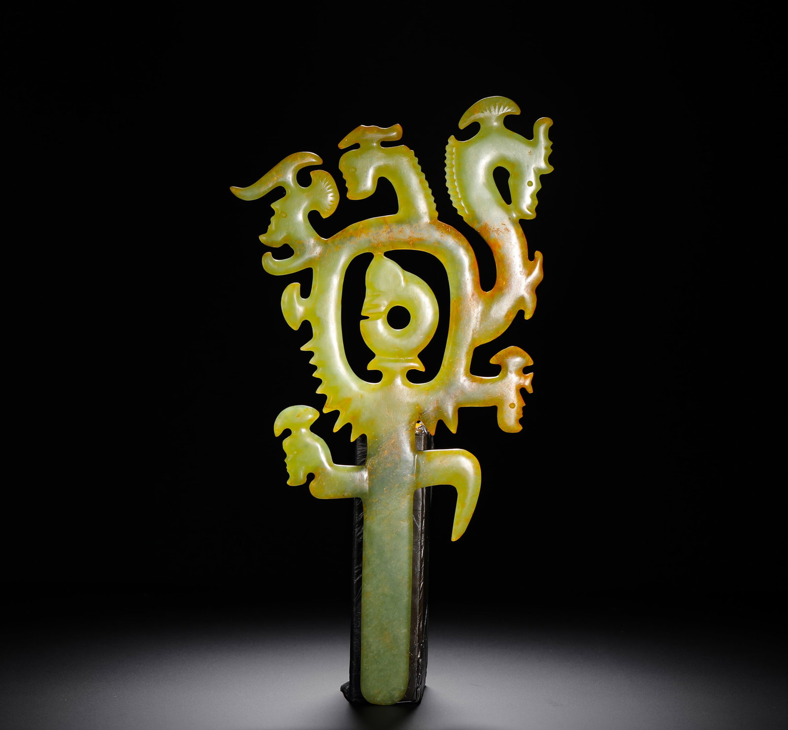 RED MOUNTAIN CULTURE JADE RITUAL VESSELS: Height:34.5cm(13.58in) Width:18cm(7.09in) Weight:380g(0.84lb)Hongshan Culture yellow jade hollowed ornament carved with multi-dragon and human deity. Solid jade openwork carving with long gui-shaped h