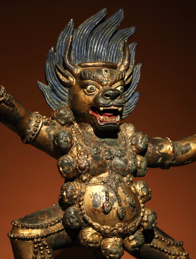 A GILDED BRONZE VAJRA STATUE FROM THE MING DYNASTY: Weight:5600gH:37cmL:32cmW:17cmThis is a Tibetan Buddhist gilt-bronze statue of a wrathful protector, depicted in a standing posture with a fierce face, protruding fangs, a flame-shaped halo on the