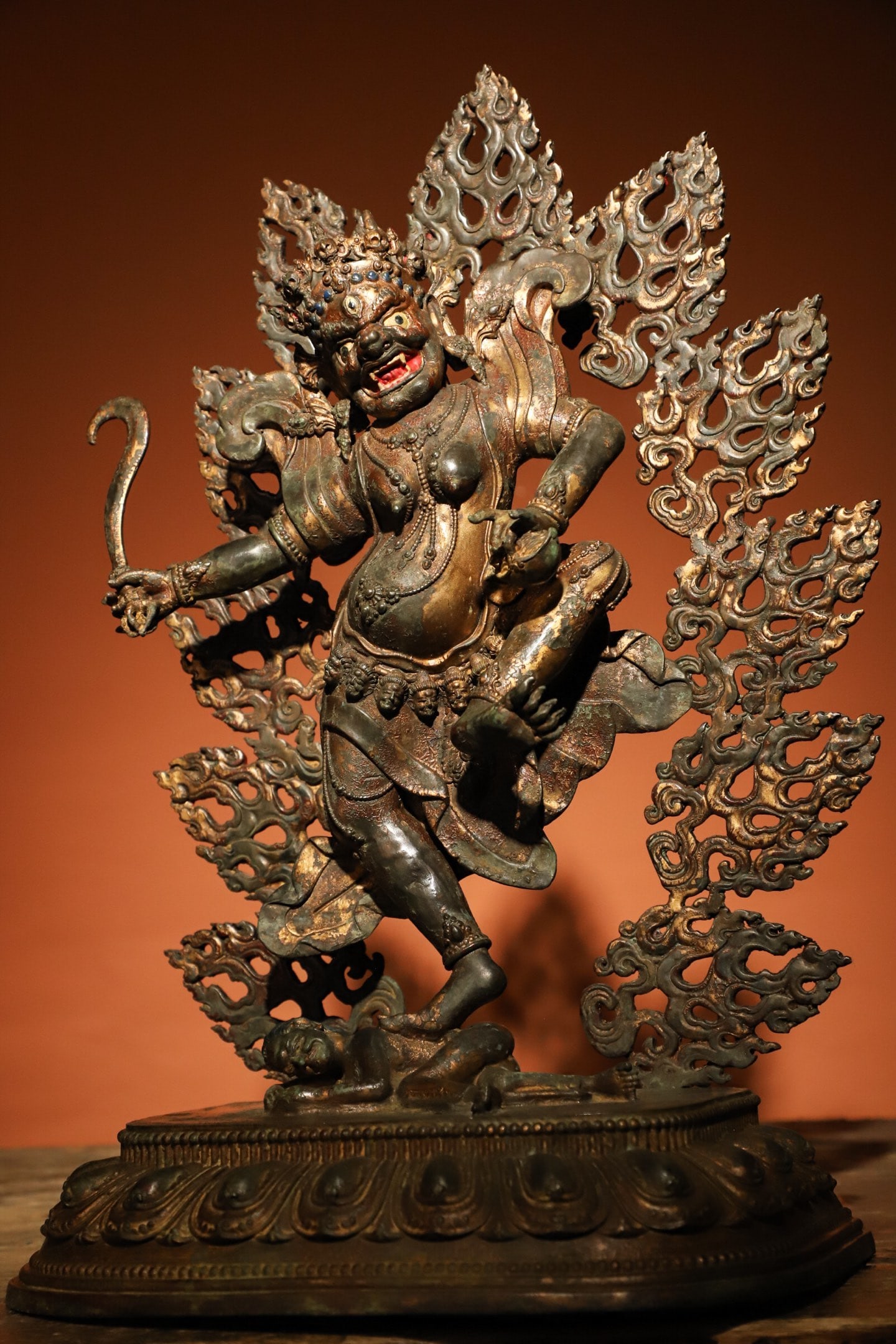 GILDED BRONZE FIGURES OF THE MING DYNASTY: Weight:4200g.H:40cmL:26cmW:14cm This is a Tibetan Buddhist gilt-bronze statue of a wrathful Dakini, depicted in a dynamic standing posture with one foot trampling a demon, surrounded by a