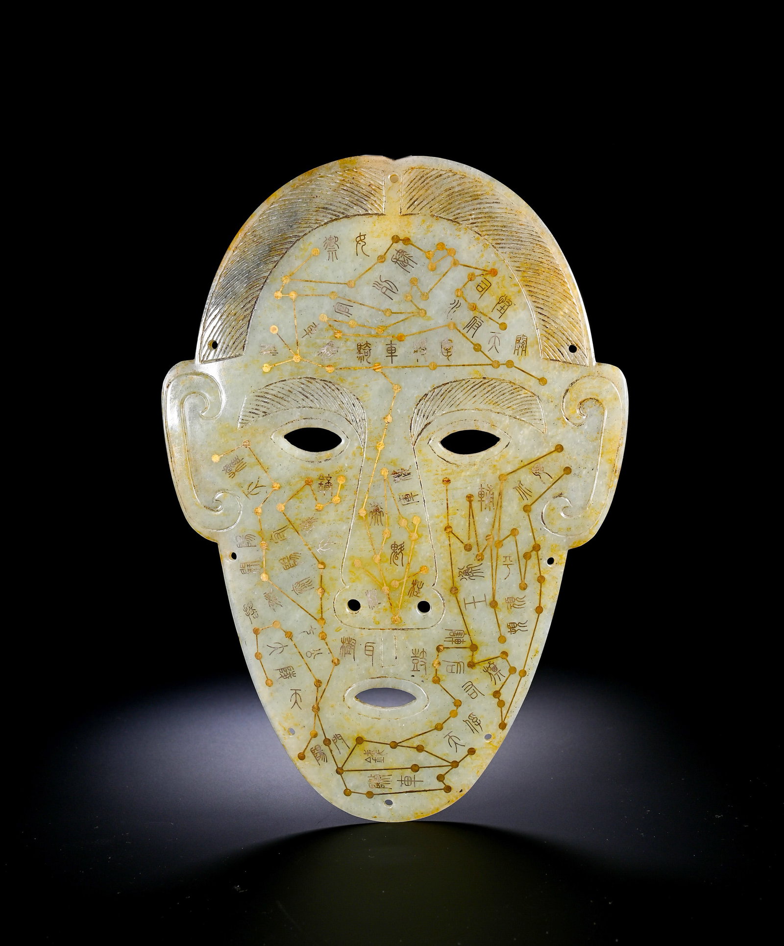 HAN AND WEI HETIAN JADE DUNJIA HUMAN FACE MASK: Height:21.8cmWidth:15.3cmWeight:190gAncient jade golden-inlaid human-face mask for Dunjia art, Han-Wei Dynasty. Carved from pale Hotan jade covered with yellowish-brown burial russet. Shaped as human 
