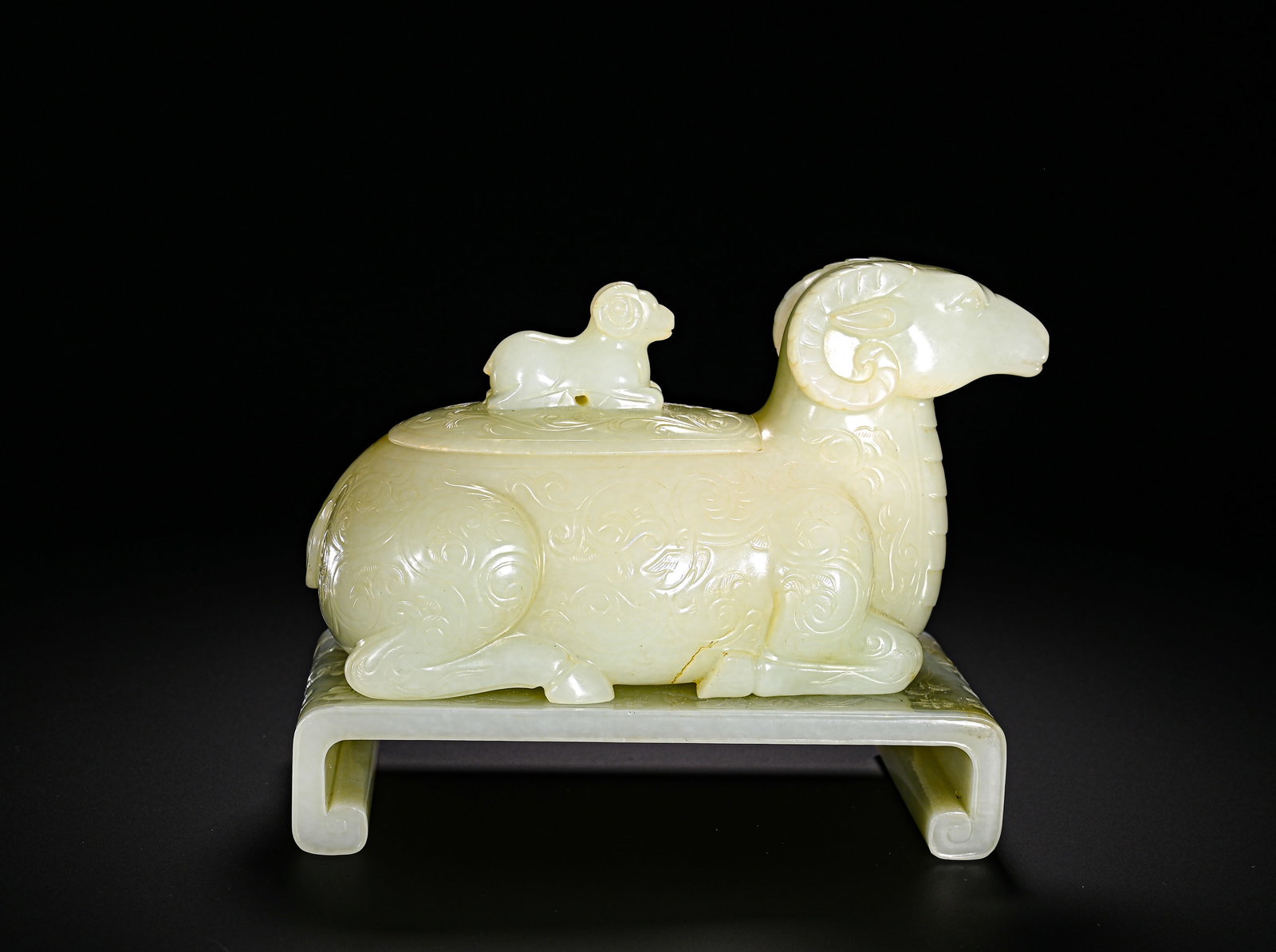 QING DYNASTY HETIAN JADE THREE YANG KAI TAI JADE SHEEP INCENSE BURNER: Height:12.5cm(4.92in)Width:14.8cm(5.83in)Weight:970g(2.14lb)Qing Dynasty Hetian jade censer shaped as sheep, themed "Three Yangs Bring Prosperity". The incense burner is carved into a recumbent sheep 