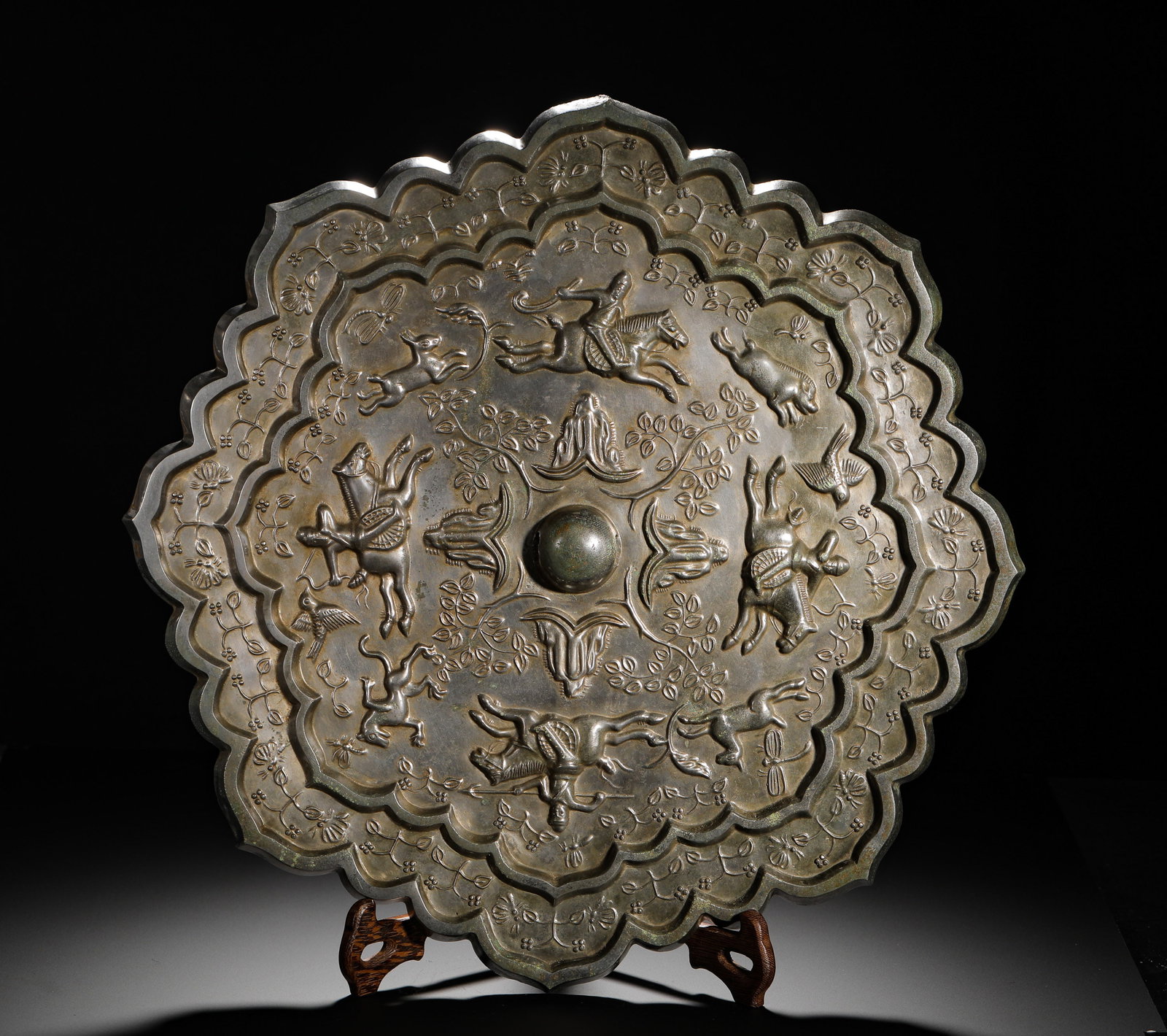 A LARGE BRONZE MIRROR WITH TWELVE RHOMBUS-SHAPED FLOWER HUNTING PATTERNS OF THE TANG DYNASTY