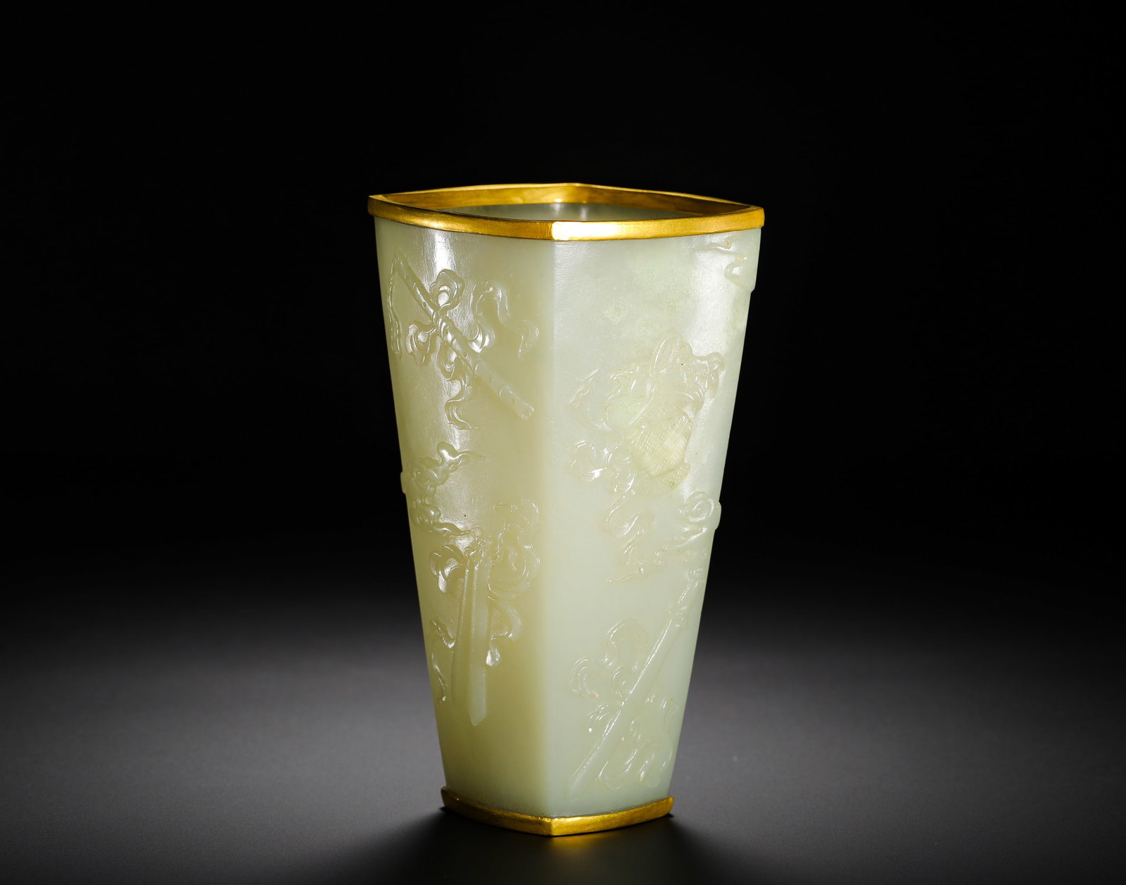 HETIAN WHITE JADE PEN HOLDER FROM THE QING DYNASTY: Height:13.8cm(5.43in) Width:7.5cm(2.95in) Weight:210g(0.46lb)Square tapered brush pot carved from Hetian pale celadon jade with gold rim, Qing imperial period.Hollowed from a single block of top-grade