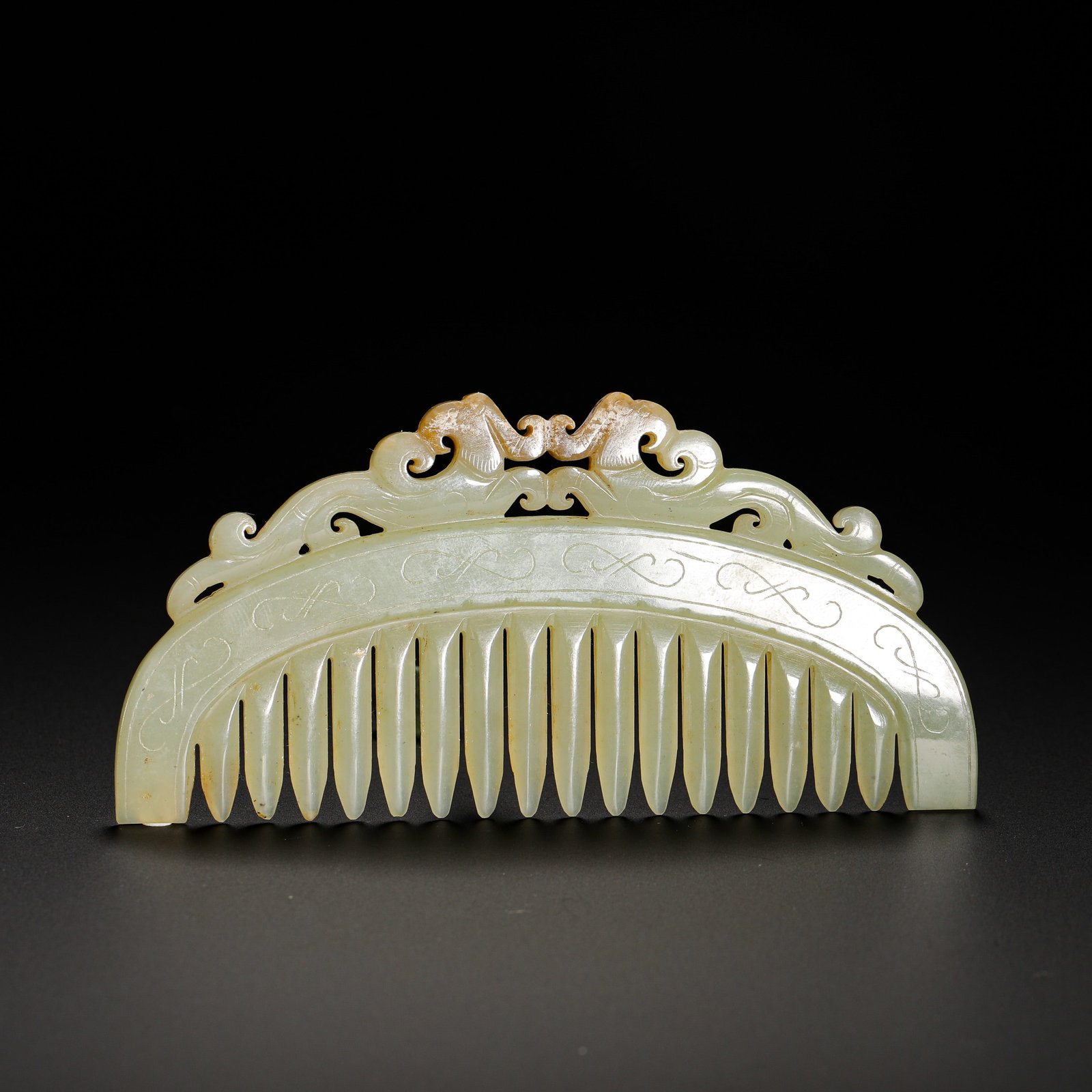 HAN DYNASTY HETIAN JADE DOUBLE PHOENIX PATTERN JADE COMB: Height:5.3cm(2.09in) Width:11cm(4.33in) Weight:50g(0.11lb)Han dynasty yellowish celadon jade comb with twin phoenix motif.Carved integrally from one jade block with natural yellow-brown aged patina an
