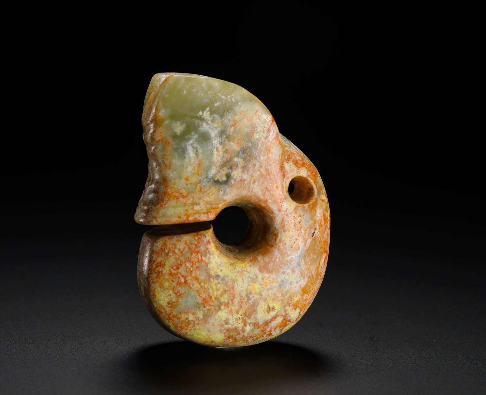 RED MOUNTAIN PERIOD JADE PIG-DRAGON: Height:6.5cm(2.56in) Width:4.5cm(1.77in) Weight:130g(0.29lb)Neolithic Hongshan cyan jade C-shaped pig-dragon ritual pendant. Integrated solid jade carving with split mouth, perforated back for threadi