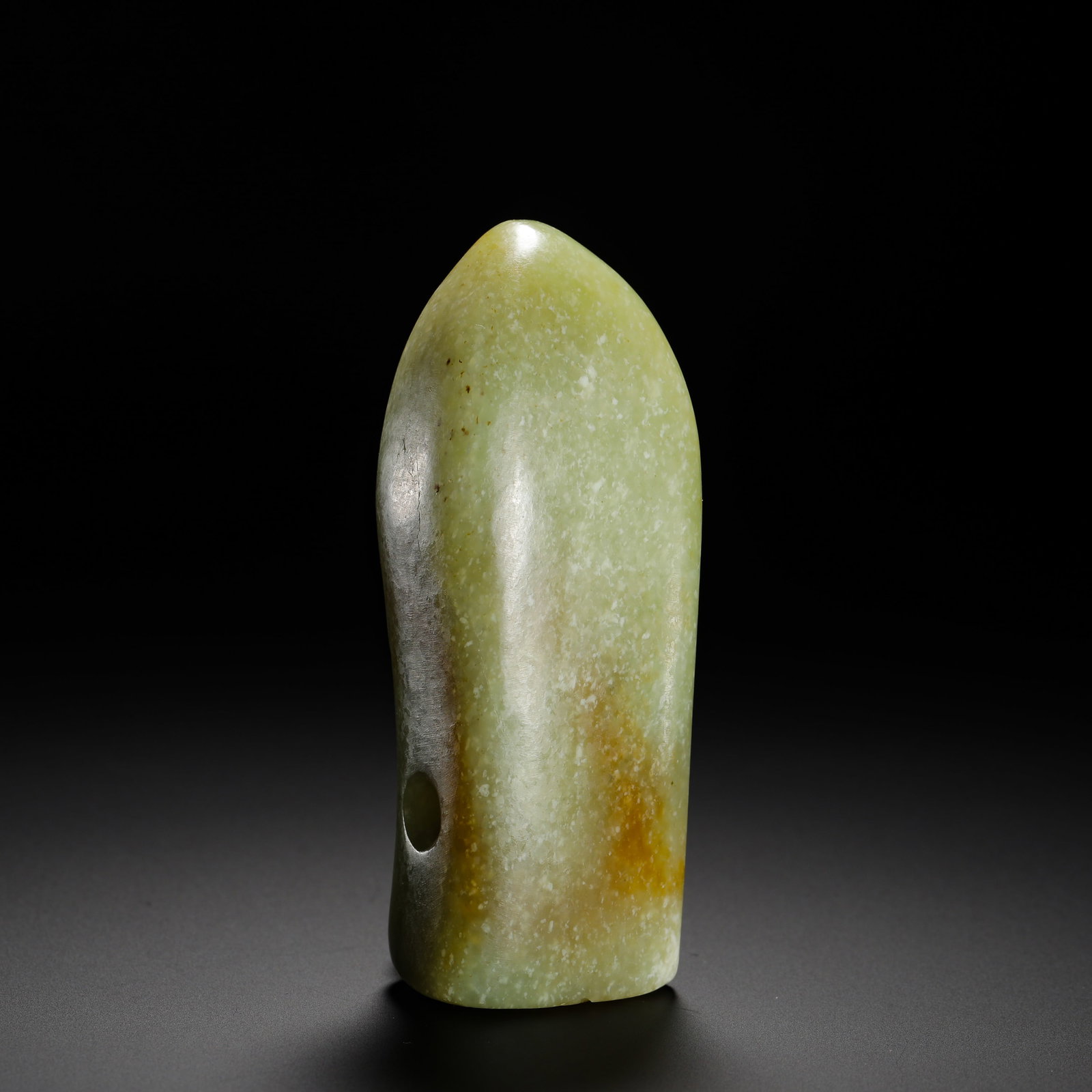 NEOLITHIC GREEN JADE CICADA-SHAPED PENDANT: Height:3.5cm(1.38in) Width:10.5cm(4.13in) Weight:280g(0.62lb)Neolithic celadon jade cicada pendant.Carved integrally from yellowish-green jade with natural white-grey speckled patina and russet stains