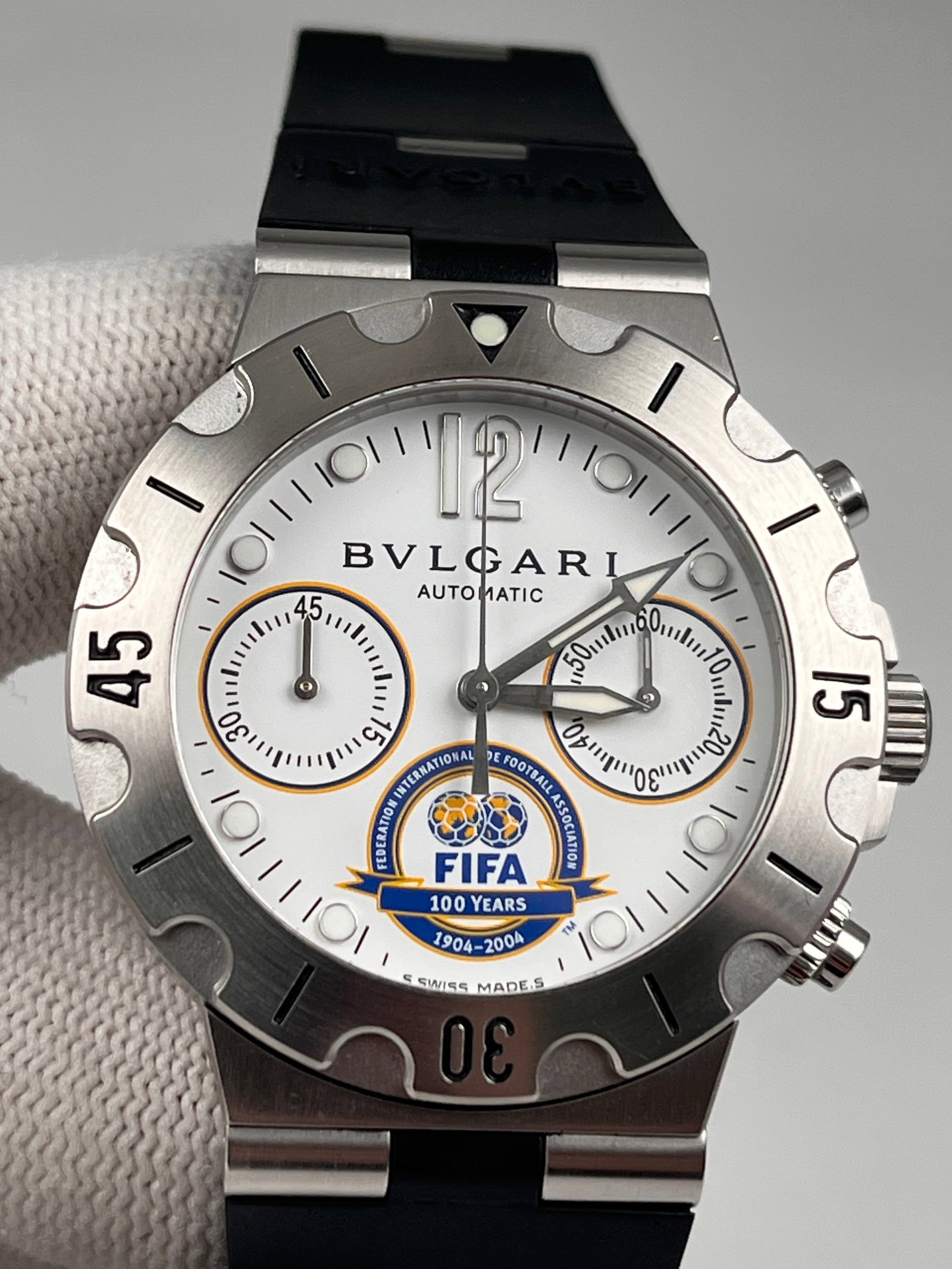 Bvlgari watches: Limited to 999 pieces, a 38mm stainless steel case housing an automatic chronograph movement, featuring a white three-register chronograph dial, solid case back, and sapphire crystal glass.