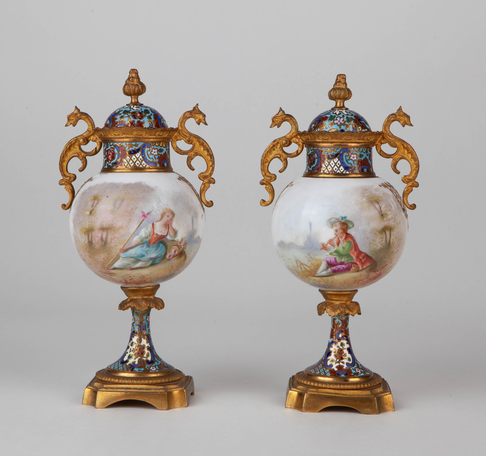 two late 19th-century French Louis XVI-style brass cloisonne and painted enamel two-handled lidded: Height: 19.5cmDescription: These two 19th-century late French Louis XVI-style vases with double handles and lids are crafted from brass with cloisonné and painted enamel. Exquisitely made with a magn