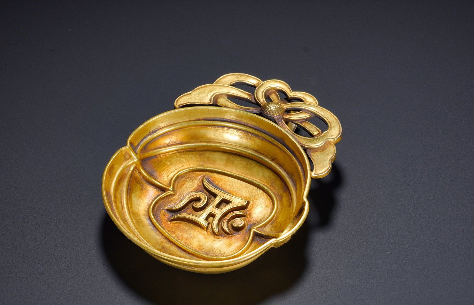 Yuan Dynasty silver-gilt peach-shaped Passpar cup: Height:3cm(1.18in), Width:13cm(5.12in), Weight:150g (0.331lb)The peach form embodies the Chinese symbolism of longevity, while the portable single handle caters to the nomadic lifestyle of the Yuan gr