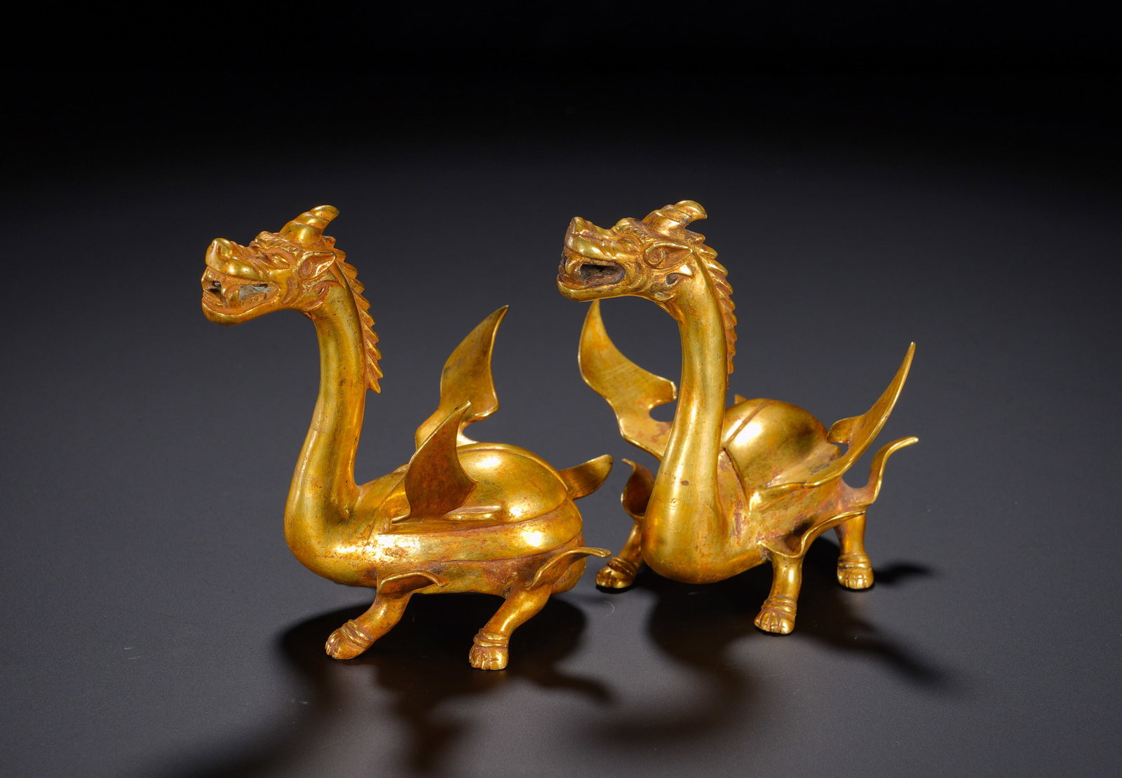 Bronze gilded winged beasts of the Han Dynasty: Height:9cm(3.54in), Width:9cm(3.54in), Weight:560g (1.235lb)Winged mythical beasts symbolise progress, protection and good fortune. A matched pair represents double blessings. Ideal as scholar’s tab