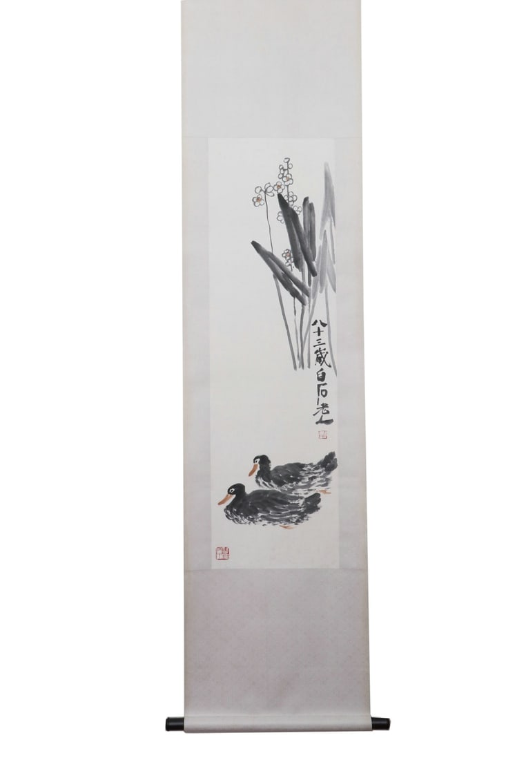 Qi Baishi (1864-1957) Two Ducks on Vertical Scroll: Height:119cm(46.85in), Width:34cm(13.39in)Hanging scroll, ink and colour on paper, painted by Qi Baishi at the age of eighty-three.Two ink ducks swim leisurely beneath calamus and wintersweet. Concise