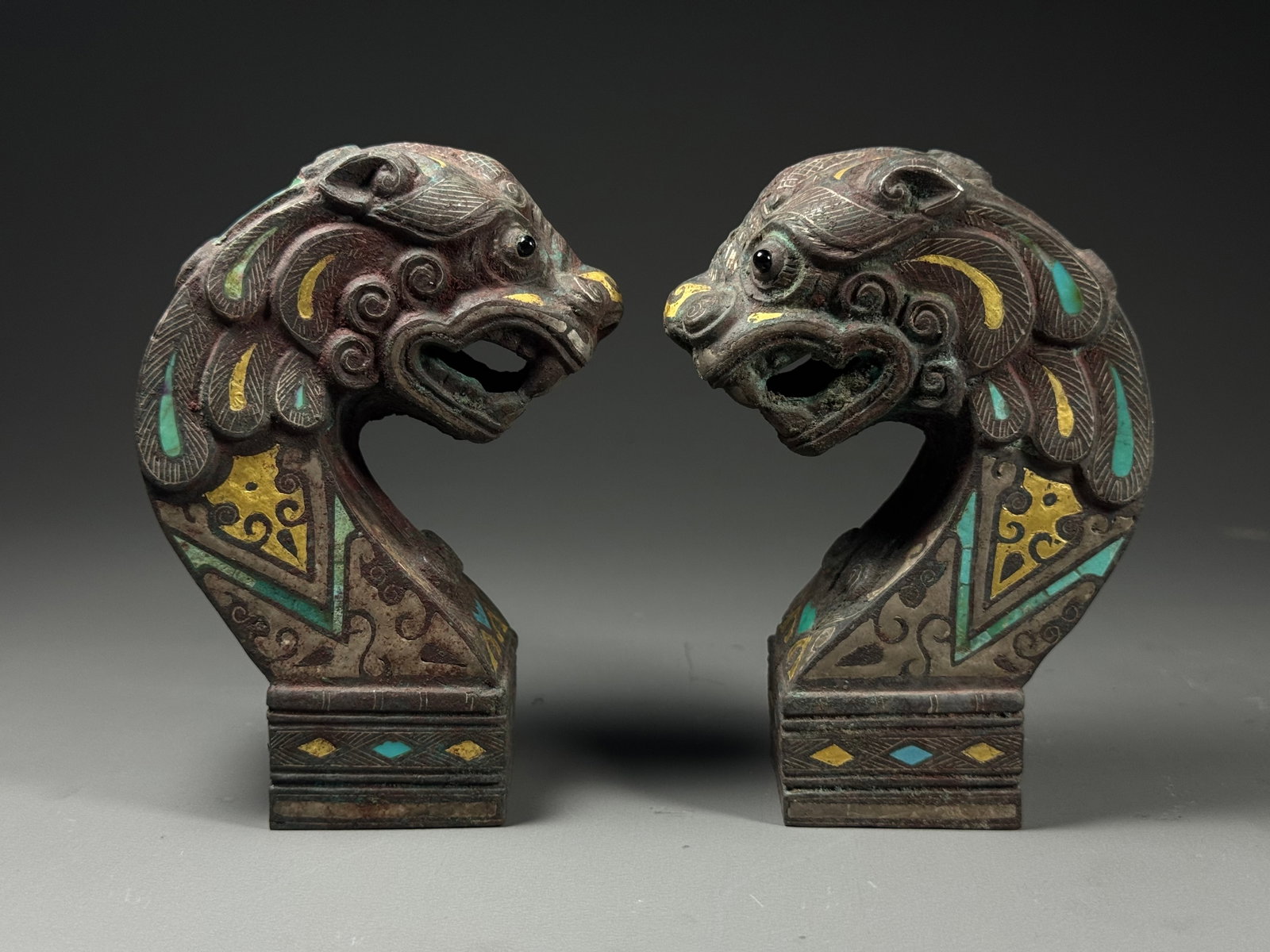 Bronze components in the shape of stone tigers with inlaid gold and silver inlaid pine from the: Height:11cm(4.33in), Width:5cm(1.97in), Weight:1132g (2.496lb)A Pair of Warring States Bronze Tiger Ornaments Inlaid with Gold, Silver and TurquoiseThis matching pair of bronze fittings is modeled as 