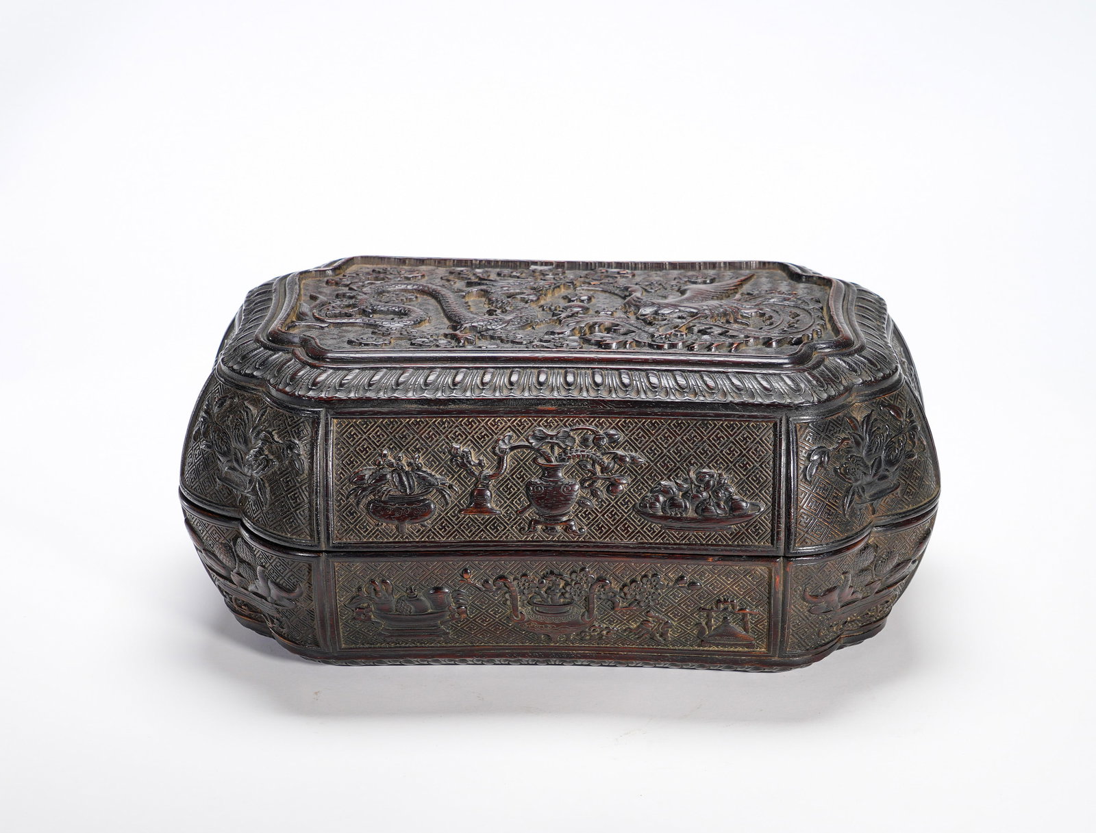 Qing Dynasty purple sandalwood rectangular lid box: Height:13cm(5.12in), Width:27cm(10.63in), Weight:1150g (2.535lb)Zitan Covered Box with Deep Relief Carved Dragon, Phoenix and Antiquities MotifsExquisitely carved from precious zitan wood, the box ado