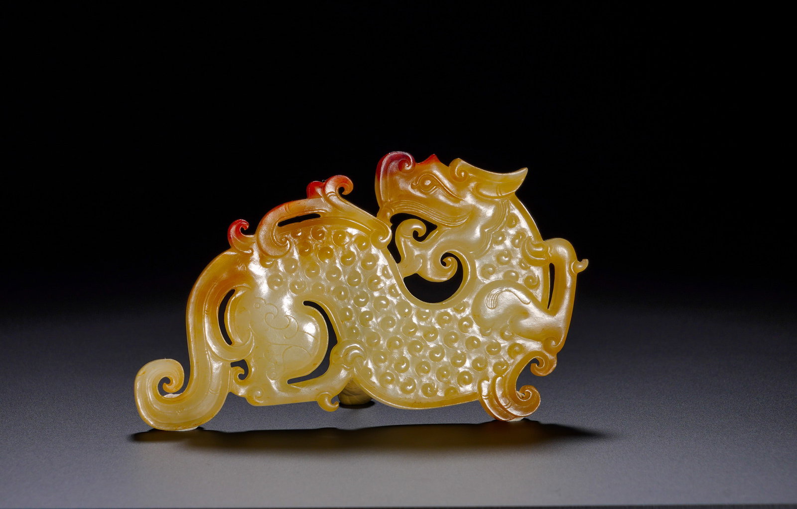A jade pendant in the shape of dragon and phoenix with grain pattern from Hetian during the Warring (1 of 9)