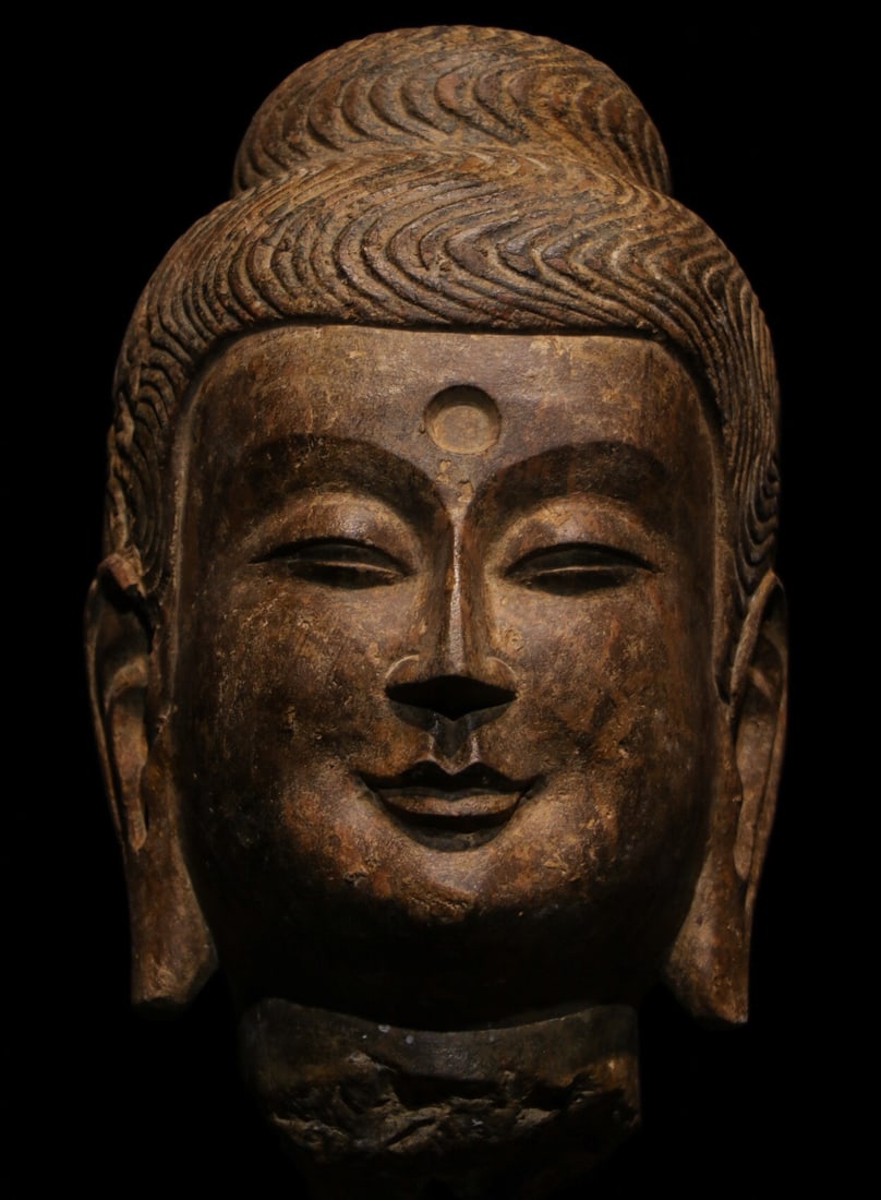 Northern Wei. Bluestone Buddha head of Sakyamuni: Height:48cm(18.90in), Height:30cm(11.81in)Bluestone Buddha head sculpture. The ushnisha is covered with neatly carved wavy hair. The rounded gentle face bears an urna on the forehead, eyes half