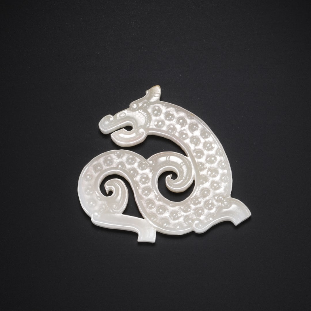 Han Hetian Jade Dragon Pendant: Long:5.6cm(2.20in), Width:5.1cm(2.01in), Thick:0.5cm(0.20in), Weight:22g (0.049lb)Openwork carved from fine Hetian white jade with light natural russet on the top. The dragon winds into a classic S si