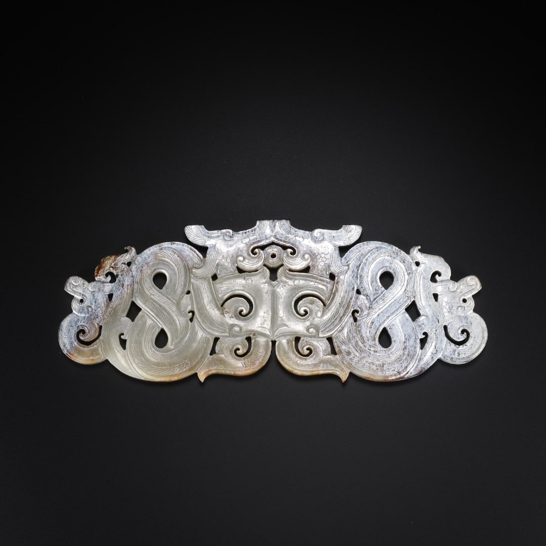 Han Hetian jade pierced Double Dragon jade pendant: Long:14cm(5.51in), Width:5.1cm(2.01in), Thick:0.5cm(0.20in), Weight:80g (0.176lb)Openwork carved from Hetian white jade covered with grey-white patina and partial russet stains. Adopting symmetrical c
