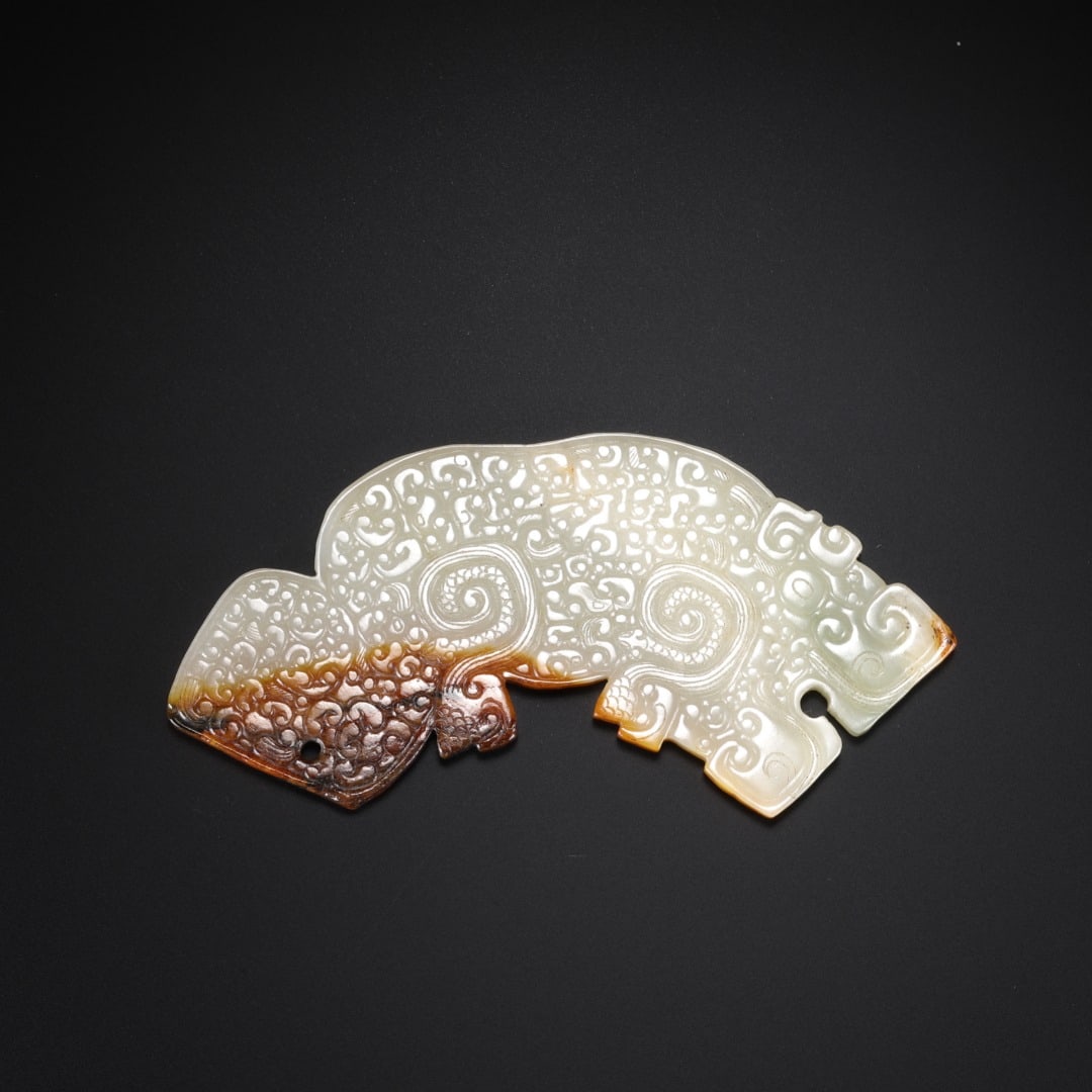 Han Hetian jade Tiger pendant: Long:9.8cm(3.86in), Width:3.7cm(1.46in), Thick:0.4cm(0.16in), Weight:35g (0.077lb)Carved from mild Hetian white jade with thick russet infiltration penetrating the jade texture at one end. Shaped as a