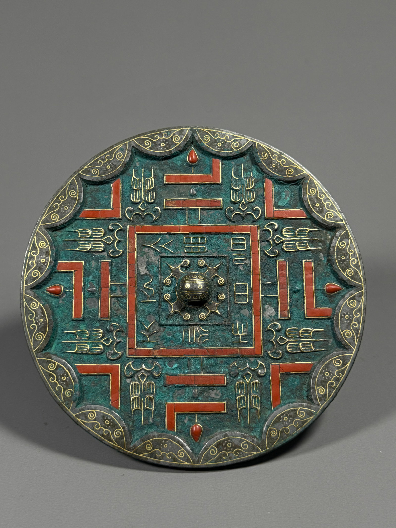 Bronze mirror with gold inlaid with red agate and geometric divine beast patterns from the Warring: Diameter:13cm(5.12in), Weight:335g (0.739lb)Warring States Gold-Inlaid Bronze Mirror with Geometric and Divine Beast Patterns Set with Red AgateRound bronze mirror with multi-curved patterned knob at 