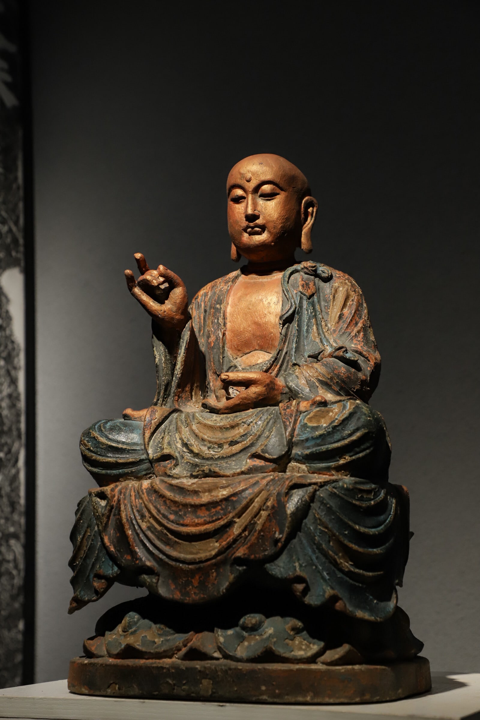 A sitting statue of the Bodhisattva Di Zang painted with gold on a wooden base of the Ming Dynasty (1 of 9)