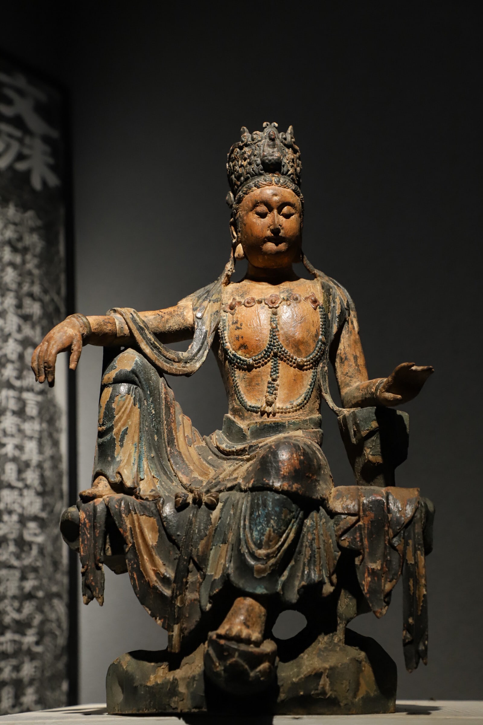 Yuan Dynasty woodblock painted seated Guanyin: Height:45cm(17.72in) Width:28cm(11.02in)Wooden polychrome free-standing Guanyin statue of Song-Yuan Dynasties. The Bodhisattva wears an ornate crown inlaid with a small Buddha figure, with a gentle an