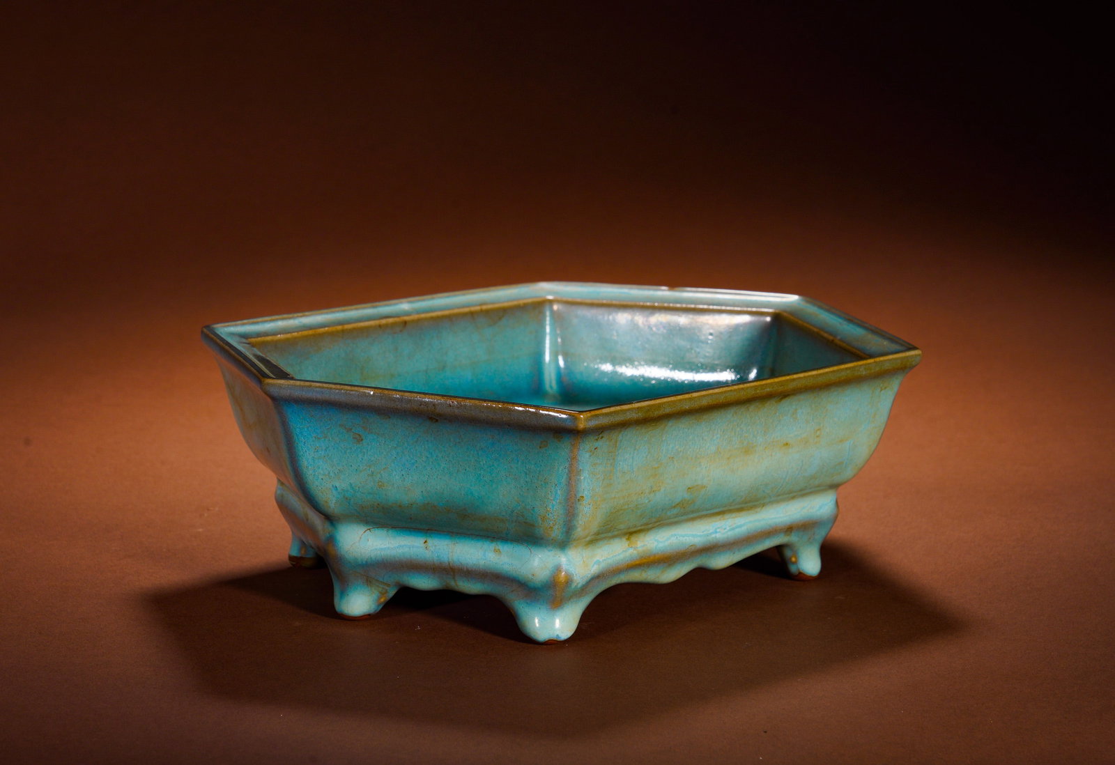 A hexagonal narcissus basin from Jun kiln of the Song Dynasty: Height:9cm(3.54in), Width:26cm(10.24in), Weight:1920g (4.233lb)This piece is a typical imperial display porcelain of official Jun kiln from the Song Dynasty. Hexagonal with folded rim, supported by fi