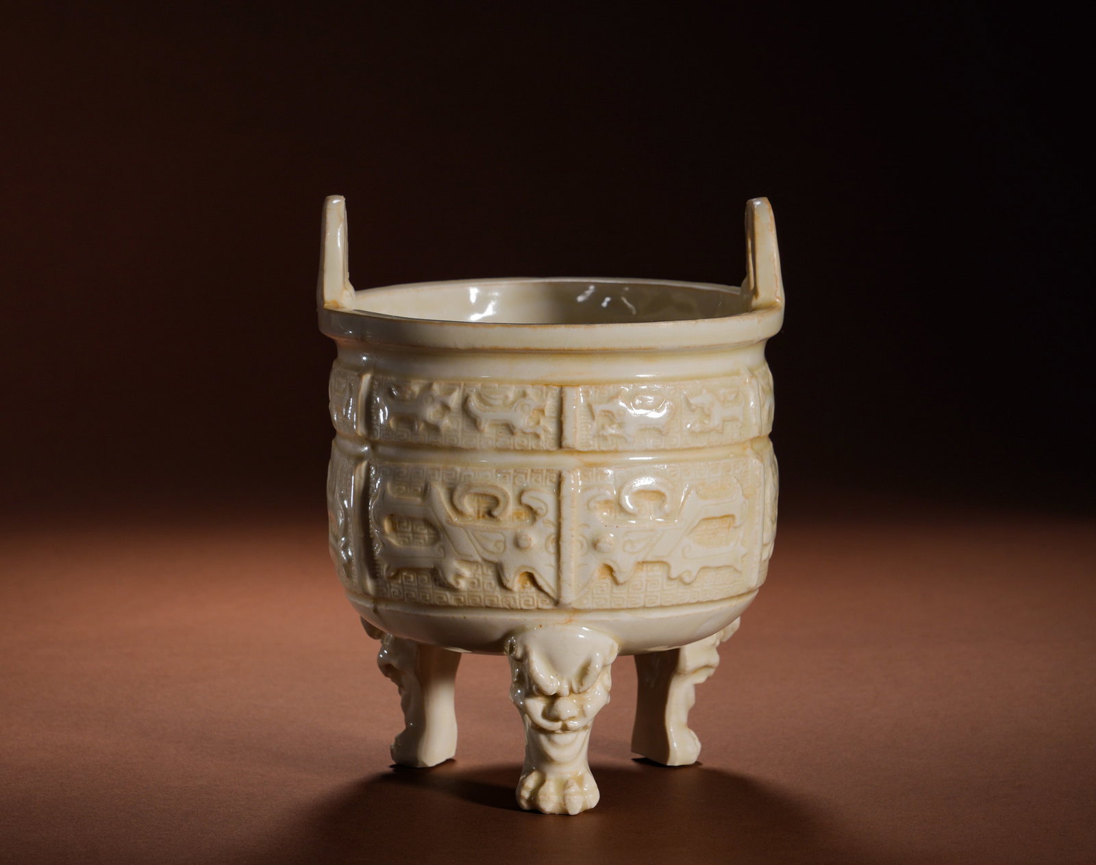 Ming Dynasty Dehua Kiln three-legged tripod furnace: Height:17cm(6.69in), Width:13cm(5.12in), Weight:600g (1.323lb)This incense burner is a classic ritual offering ware of Ming Dehua kiln. It features a wide folded rim, cylindrical body, paired square u