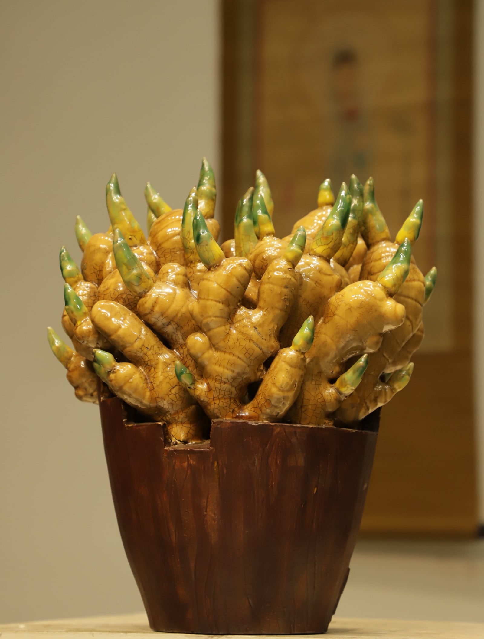 A bucket of ginger Mountain from Shiwan pottery of the Qing dynasty: Height:35cm(13.78in), Long:29cm(11.42in), Width:23cm(9.06in)This bionic porcelain artwork imitates fresh ginger contained in a wooden bucket. The ginger pieces are exquisitely sculpted. Yellow glaze w