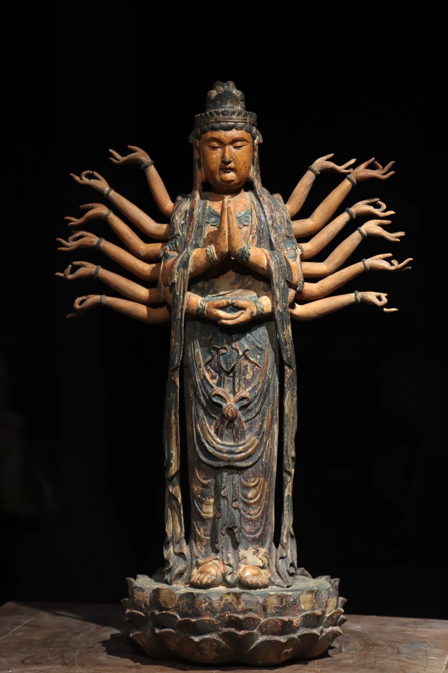 Woodcarving of Guanyin with a Thousand hands from the Song Dynasty: Height:60cm (23.62in)Wooden standing sixteen-armed Guanyin statue, hands folded and treasure mudra at chest, eight arms extended on each side, layered robe folds, lotus pedestal, traditional Chinese B