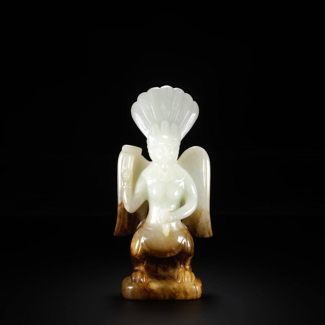 Han Dynasty Hetian jade Garuda Golden-winged bird: Long:7.3cm(2.87in), Width:3.3cm(1.30in), Height:15.6cm(6.14in), Weight:320g (0.705lb)Ancient jade statue of Garuda. Roundly carved from white jade, naturally stained with brown patina on the lower