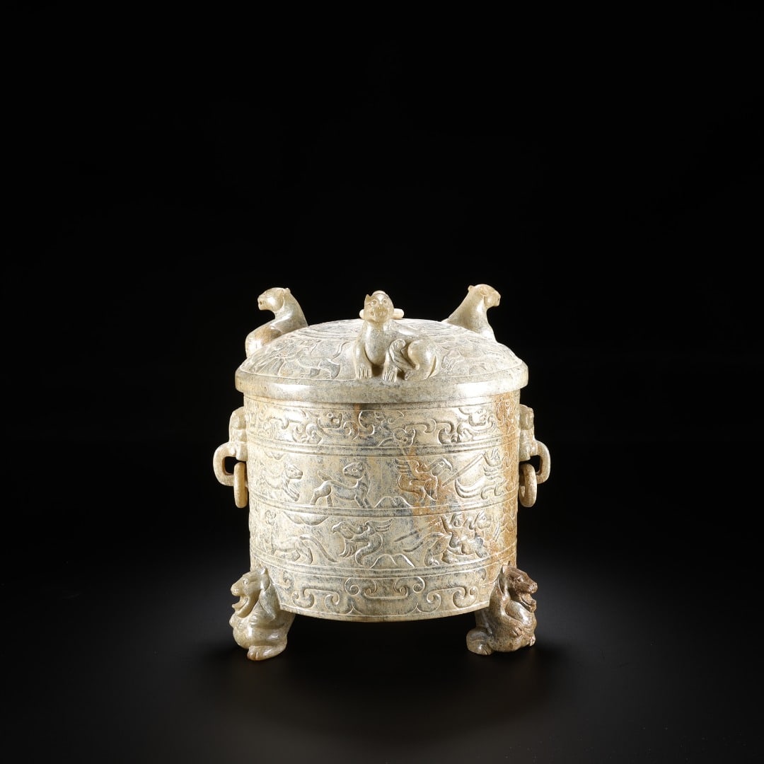 Han Dynasty Hetian jade beast-handled three-legged covered cup: Long:11cm(4.33in), Width:10.5cm(4.13in), Height:13cm(5.12in), Weight:812g (1.790lb)Ancient jade casket carved with beasts patterns, supported by beast feet and fitted with animal-head ring handles. Th
